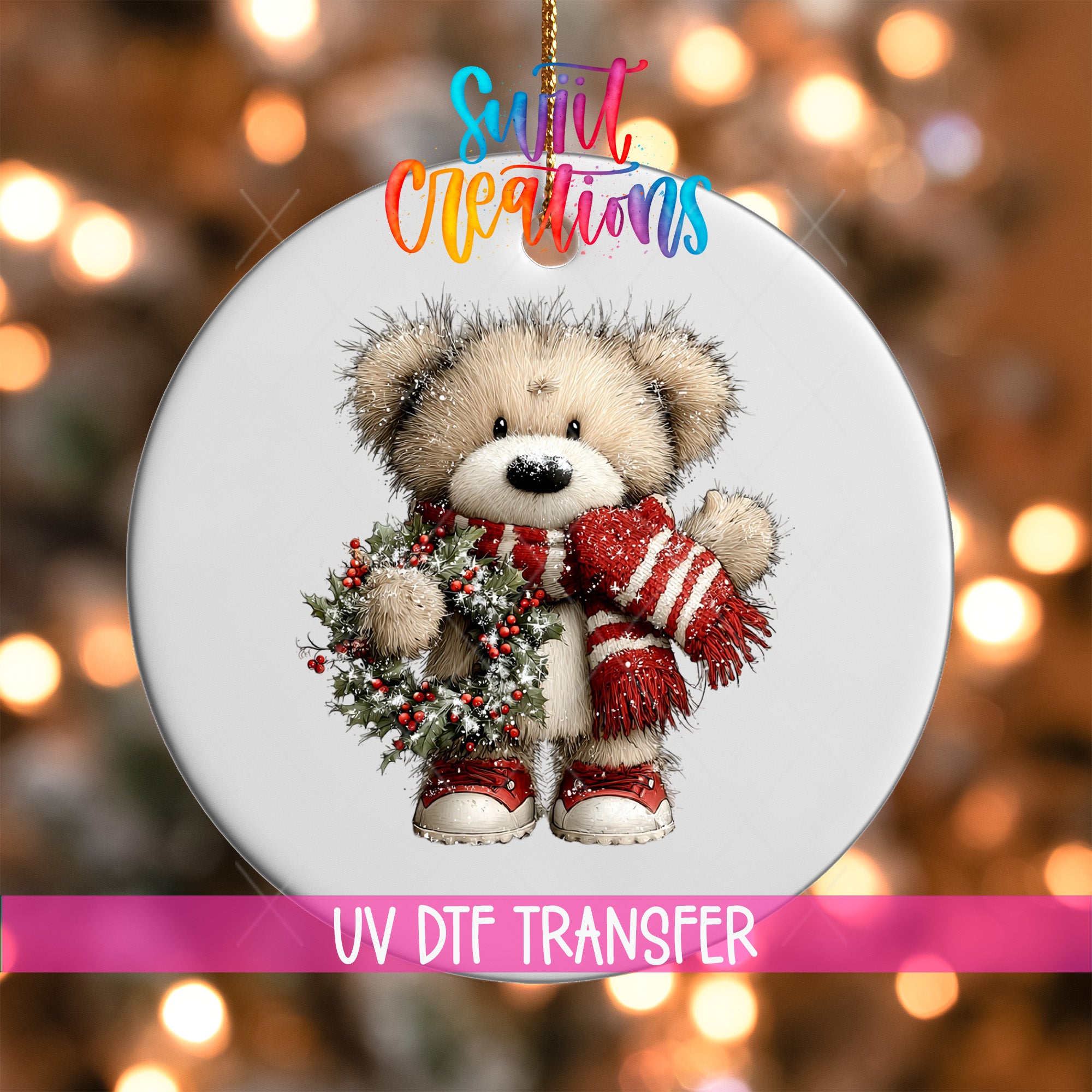 A white ornament with a teddy bear wearing a red scarf and holding a Christmas wreath.