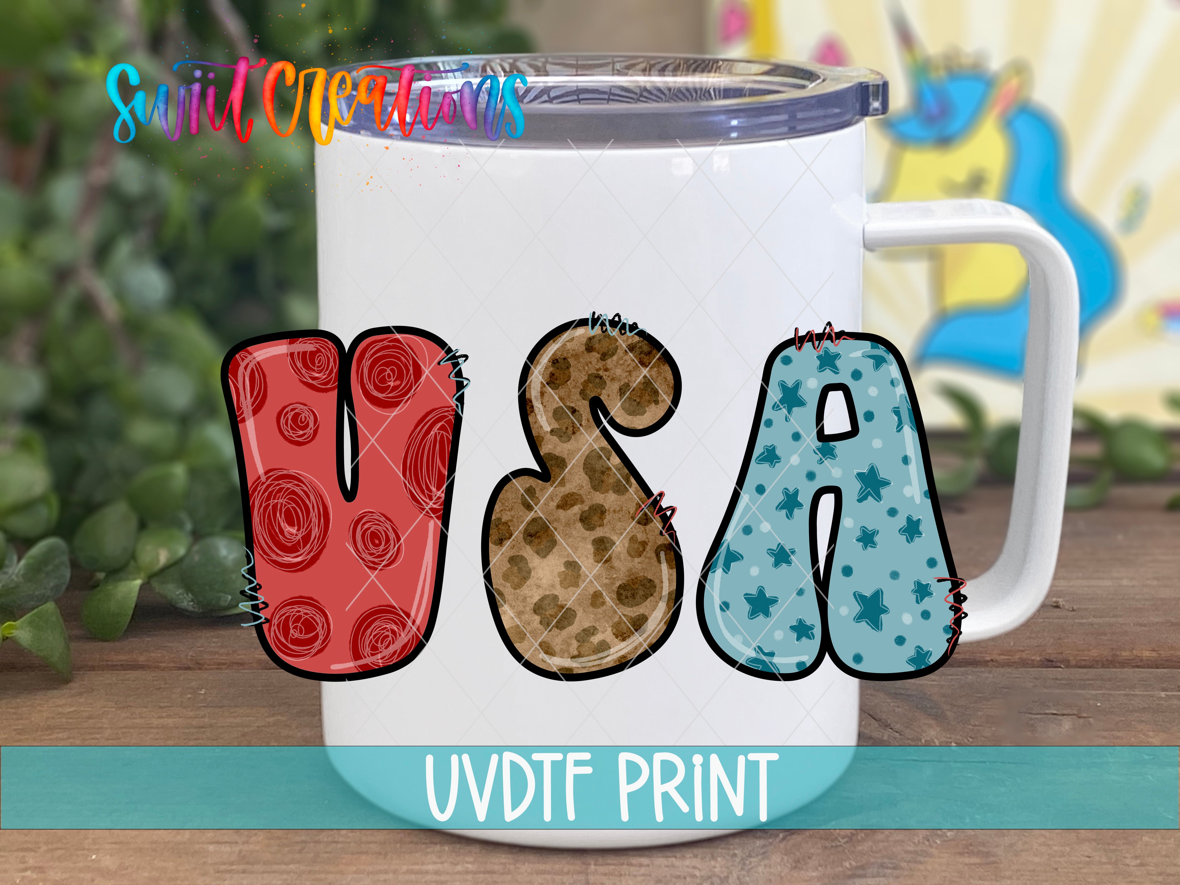 A white mug with the word "USA" printed on it, featuring various colorful and stylized letter designs.