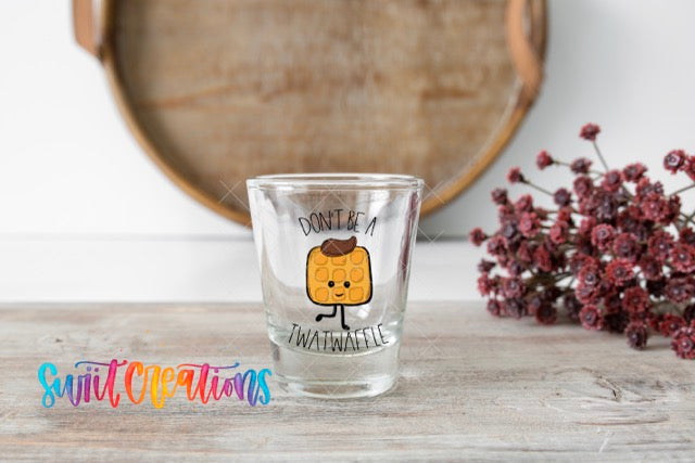 a shot glass sitting on a table with a sticker on it