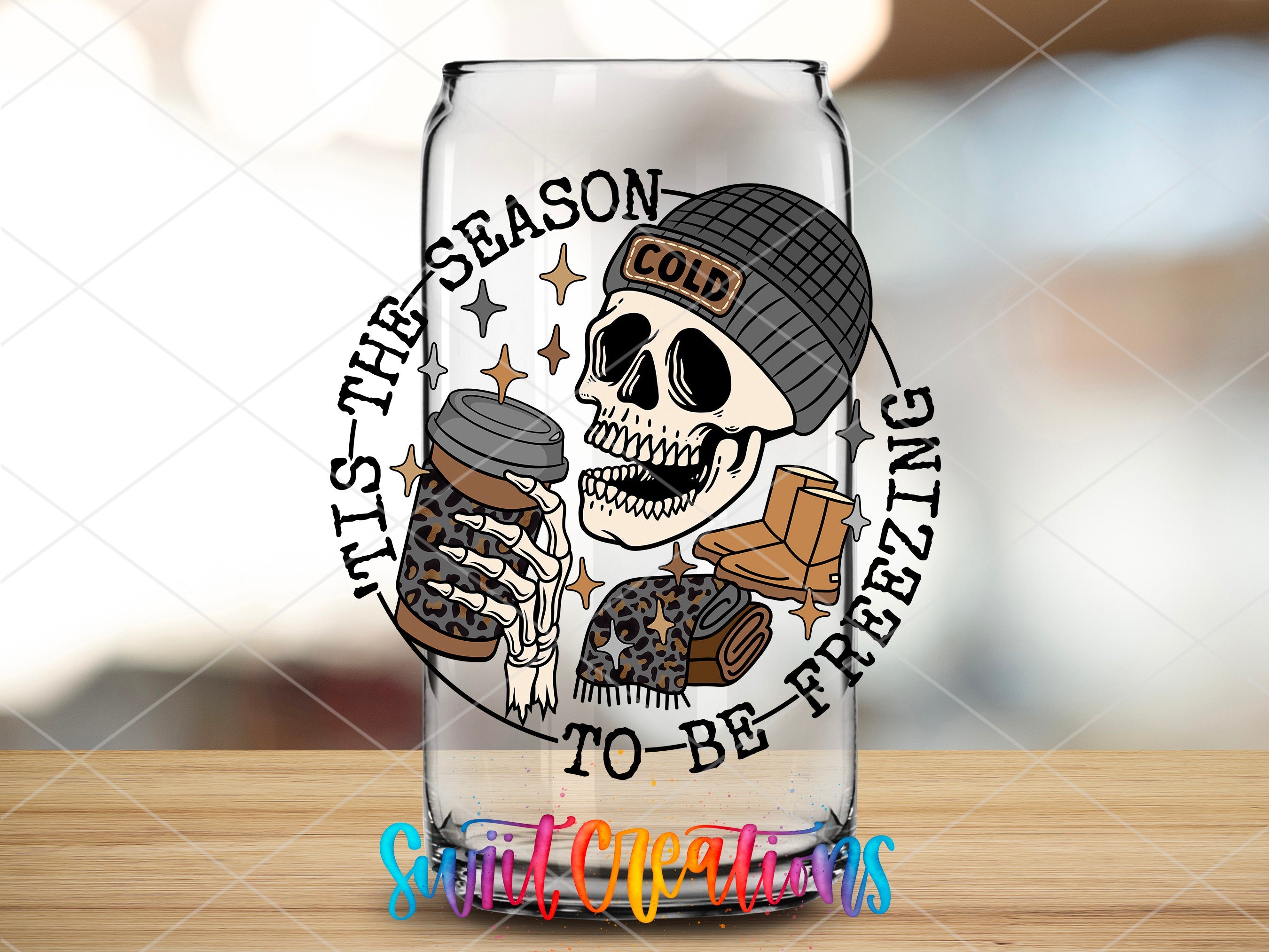 a glass with a skull holding a cookie and a jar of cookies