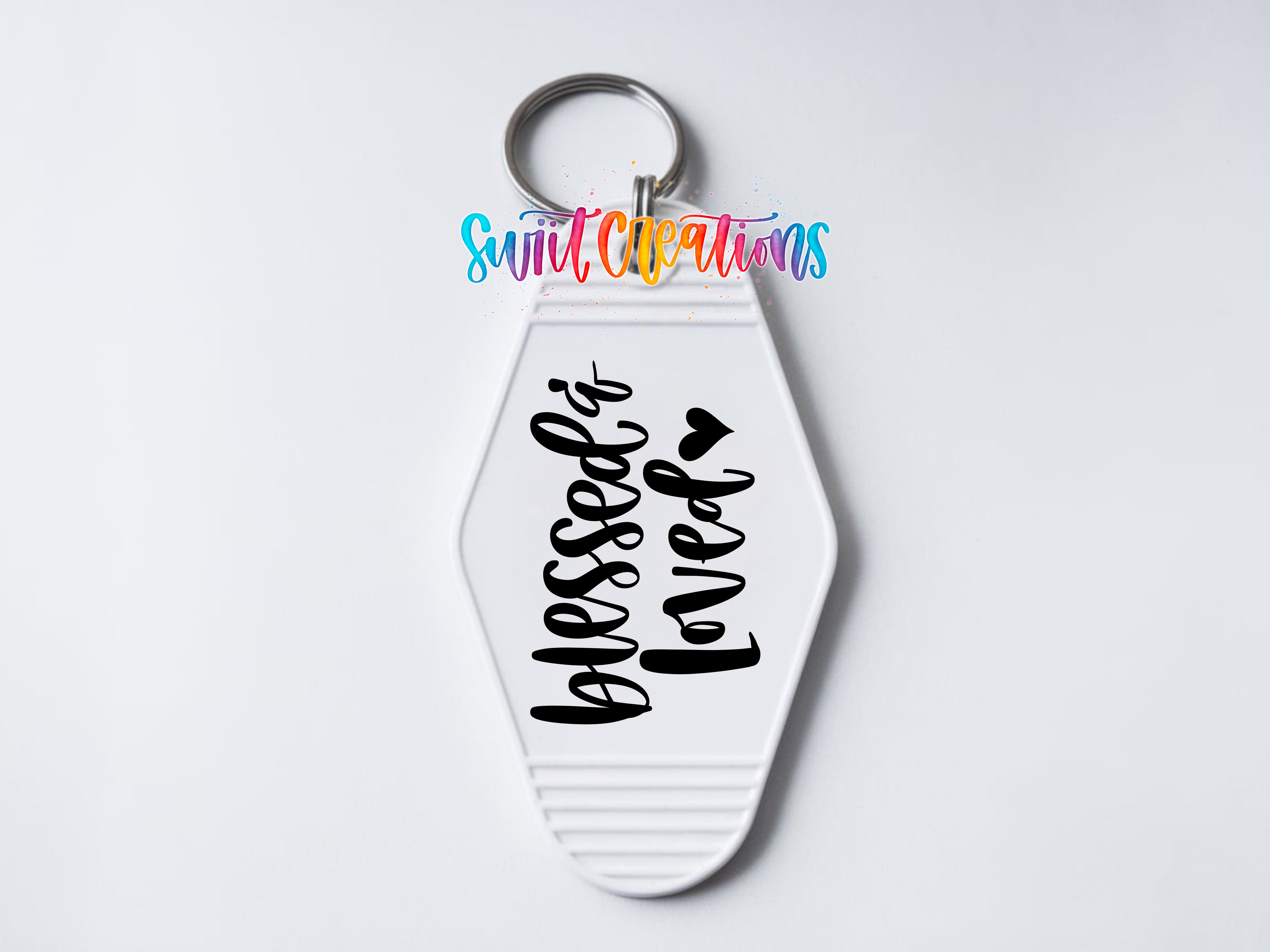 A keychain with a white keyring and a message printed on it.