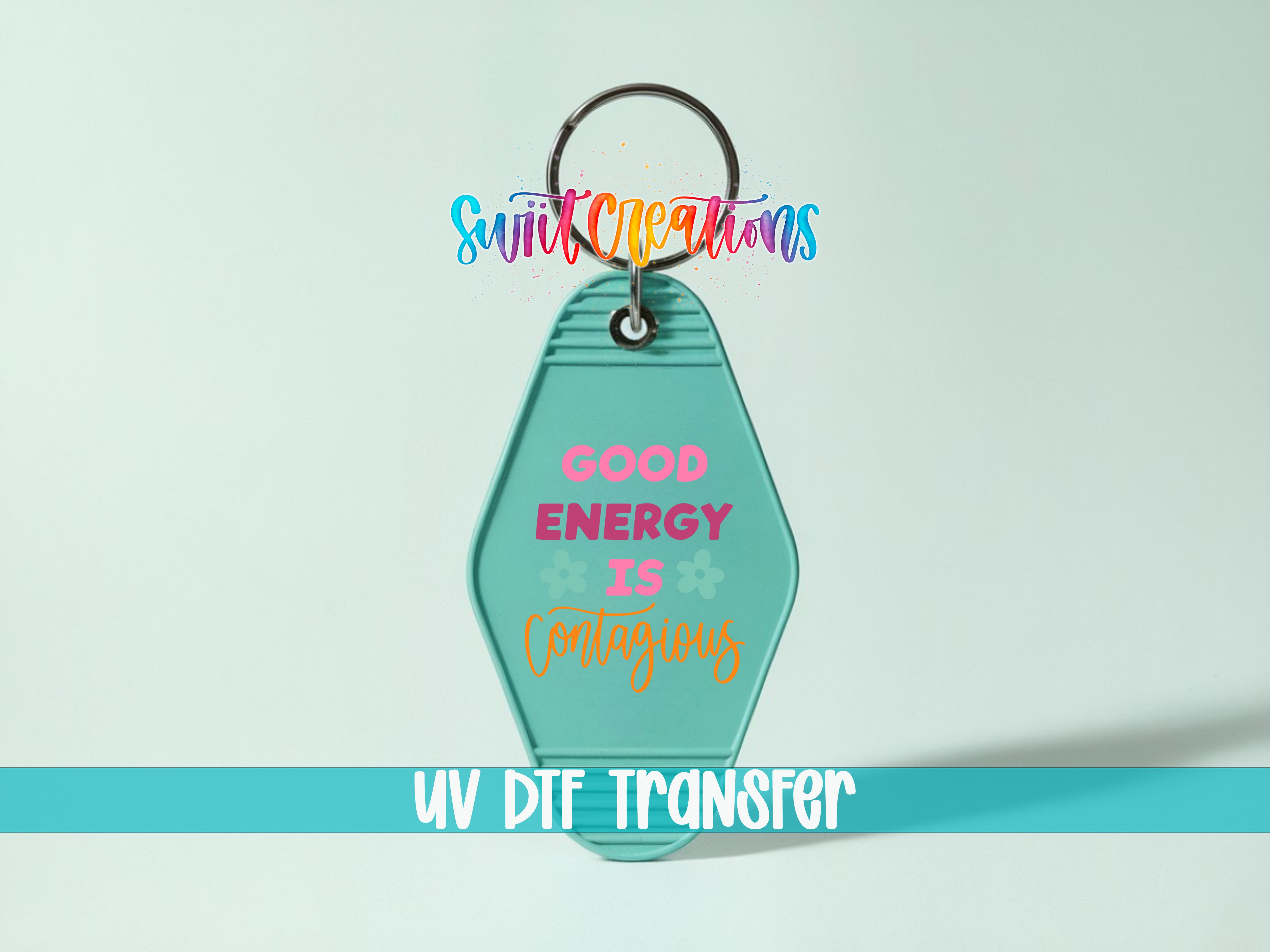 A keychain with a message that says "GOOD ENERGY IS CONTINUOUS" and a UV DIF TRANSFER logo.
