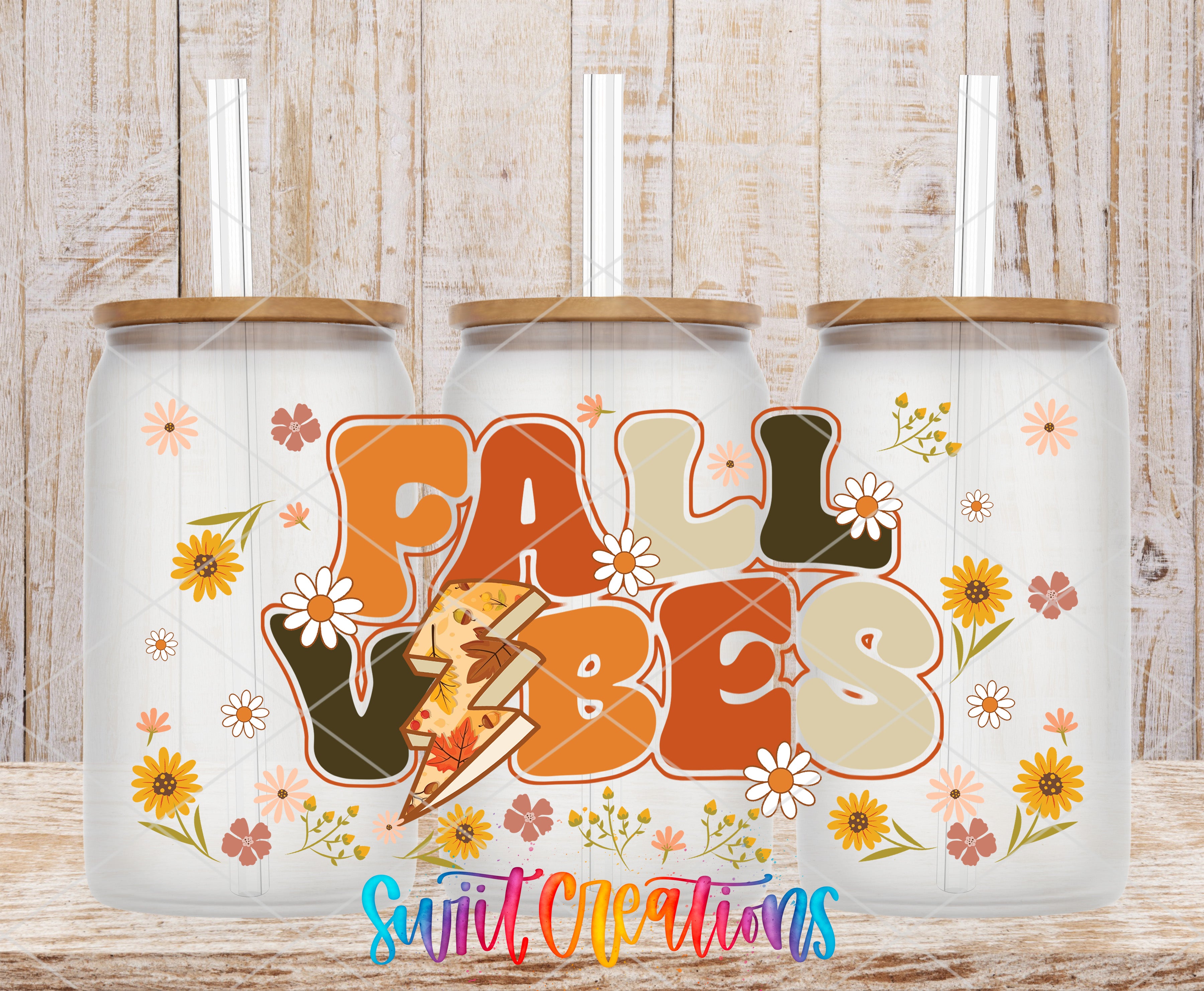 three glass jars with a colorful design and text that reads "FALL VIBES".