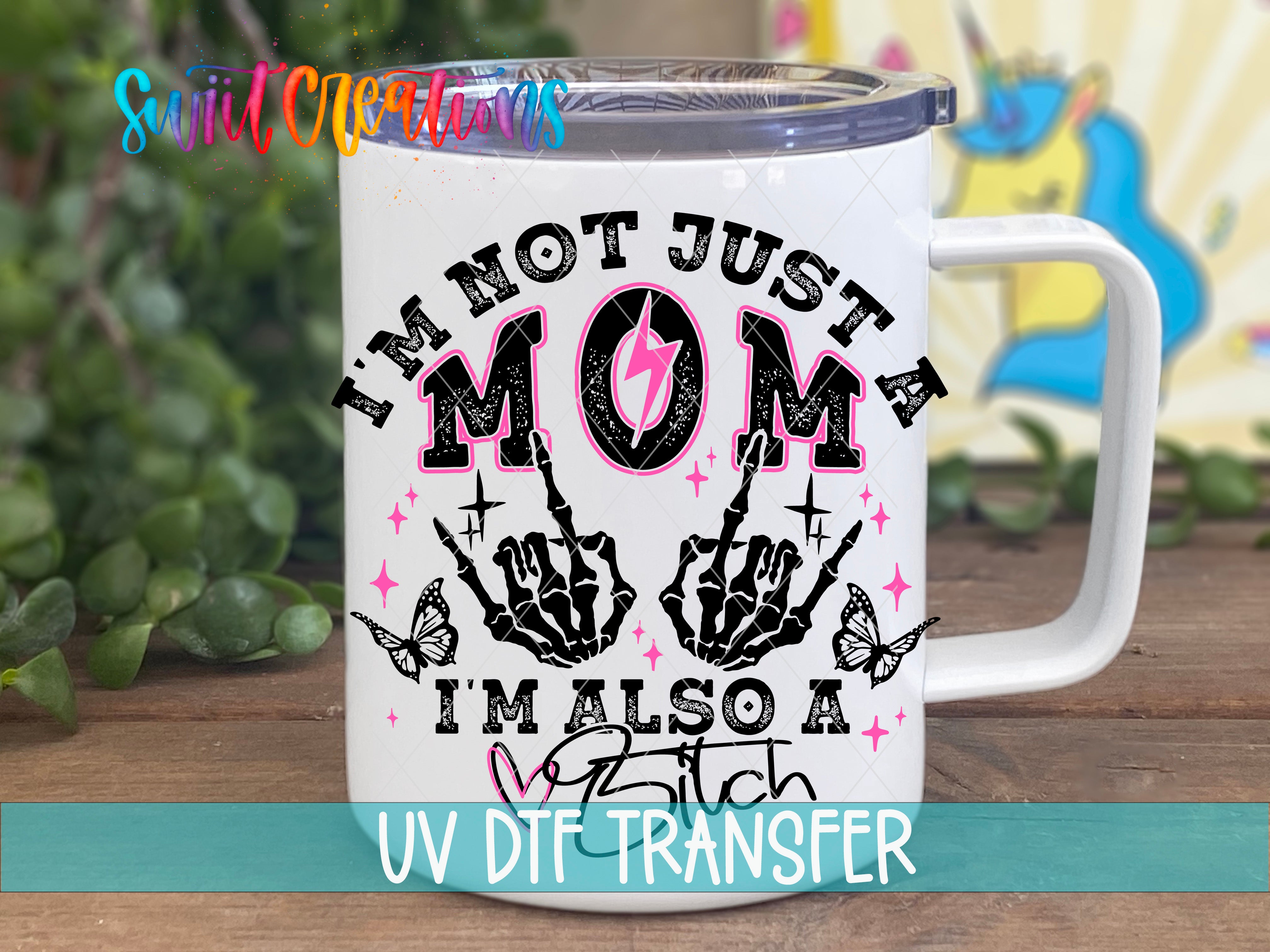 A white mug with a graphic design featuring a skeleton hand and the text "I'm not just a mom, I'm also a ditch" printed on it.