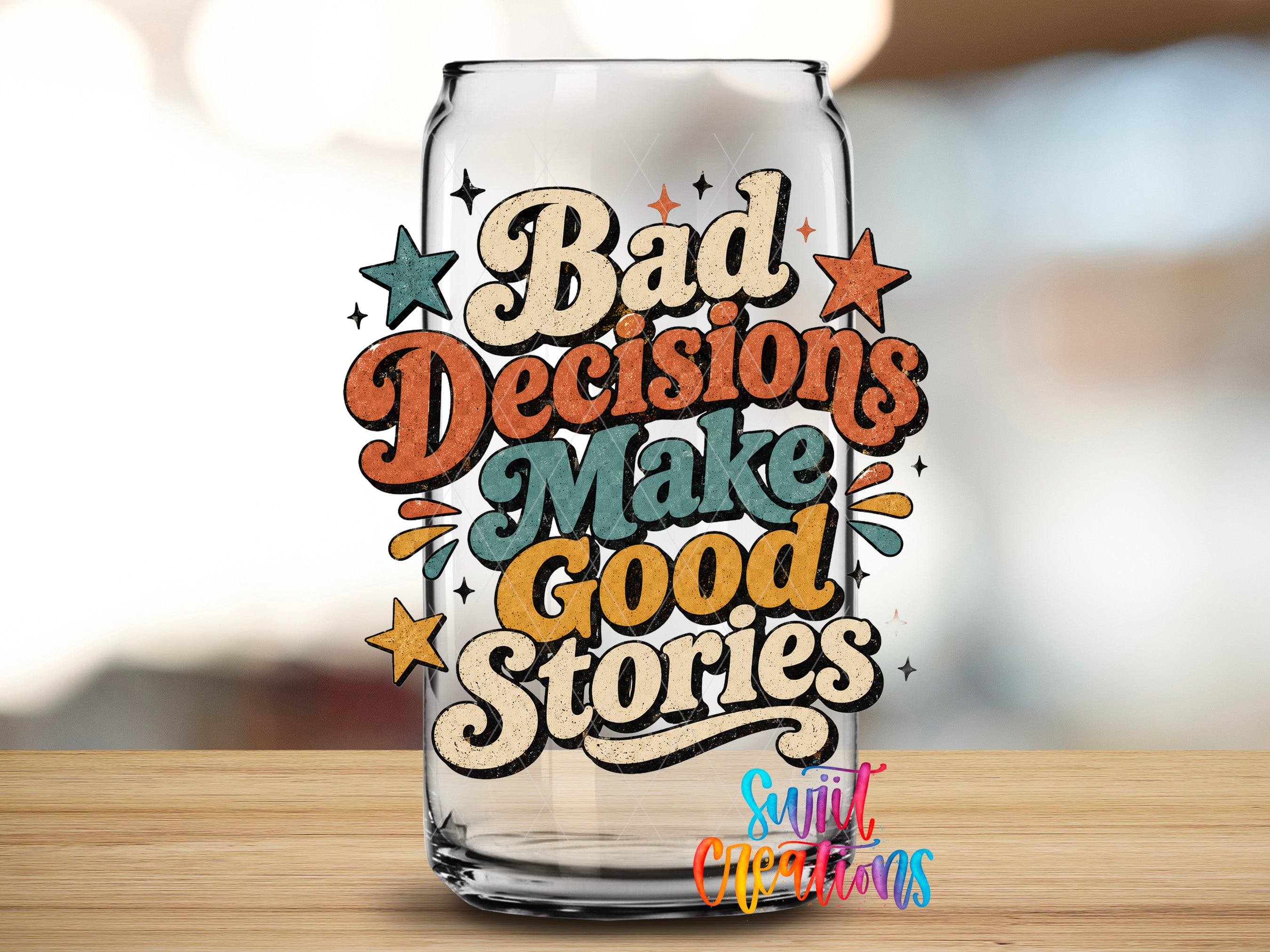 a glass can with a colorful and artistic design, including the text "Bad Decisions Make Good Stories" and various decorative elements such as stars and lines.