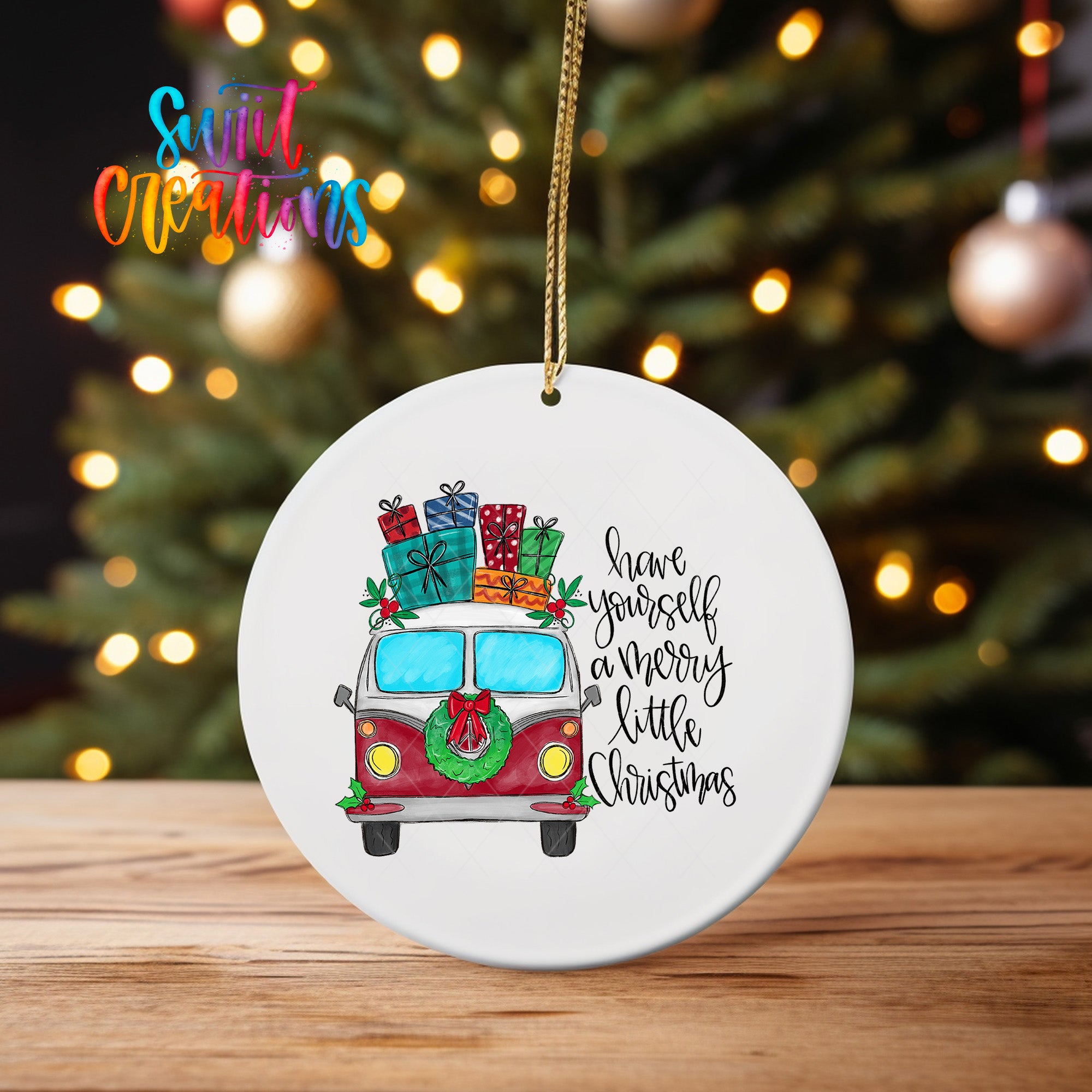 A white ceramic ornament with a red and white van decorated with Christmas presents and a wreath, hanging on a string.