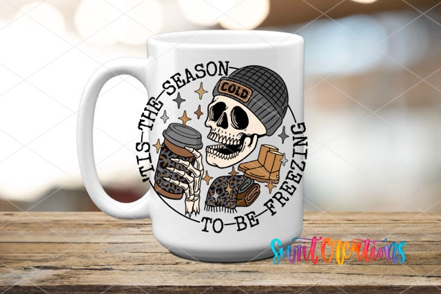 a white coffee mug with a skull holding a cup of coffee