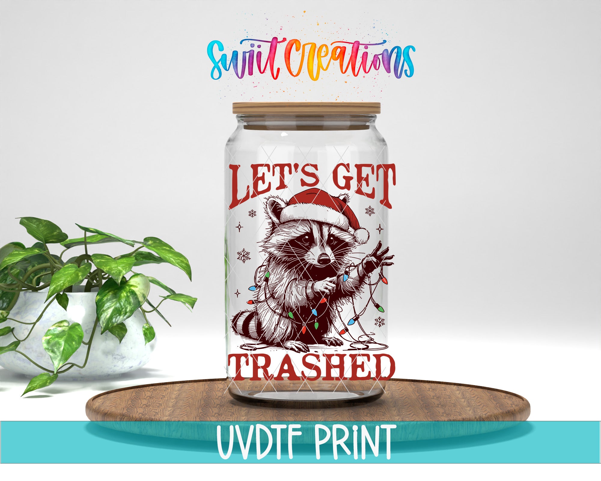 A jar with a raccoon wearing a Santa hat and the text "Let's get trampled" printed on it, placed on a wooden surface.