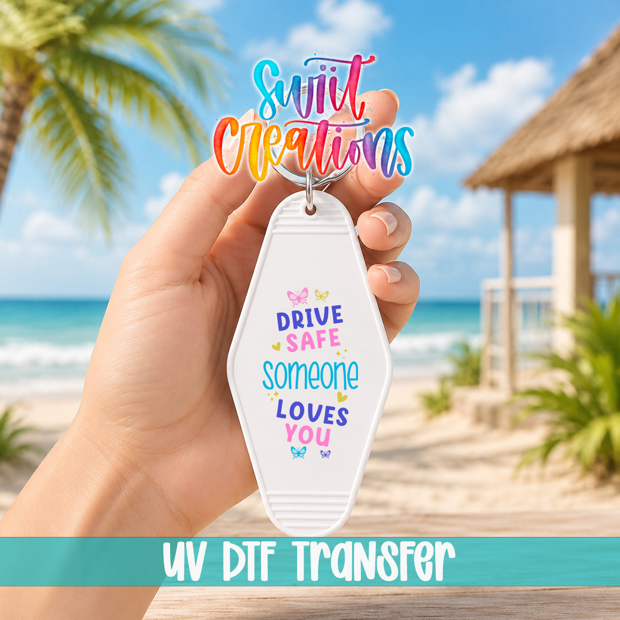 A hand holding a keychain with a message about driving safely and loving someone, with a beach and palm trees in the background.
