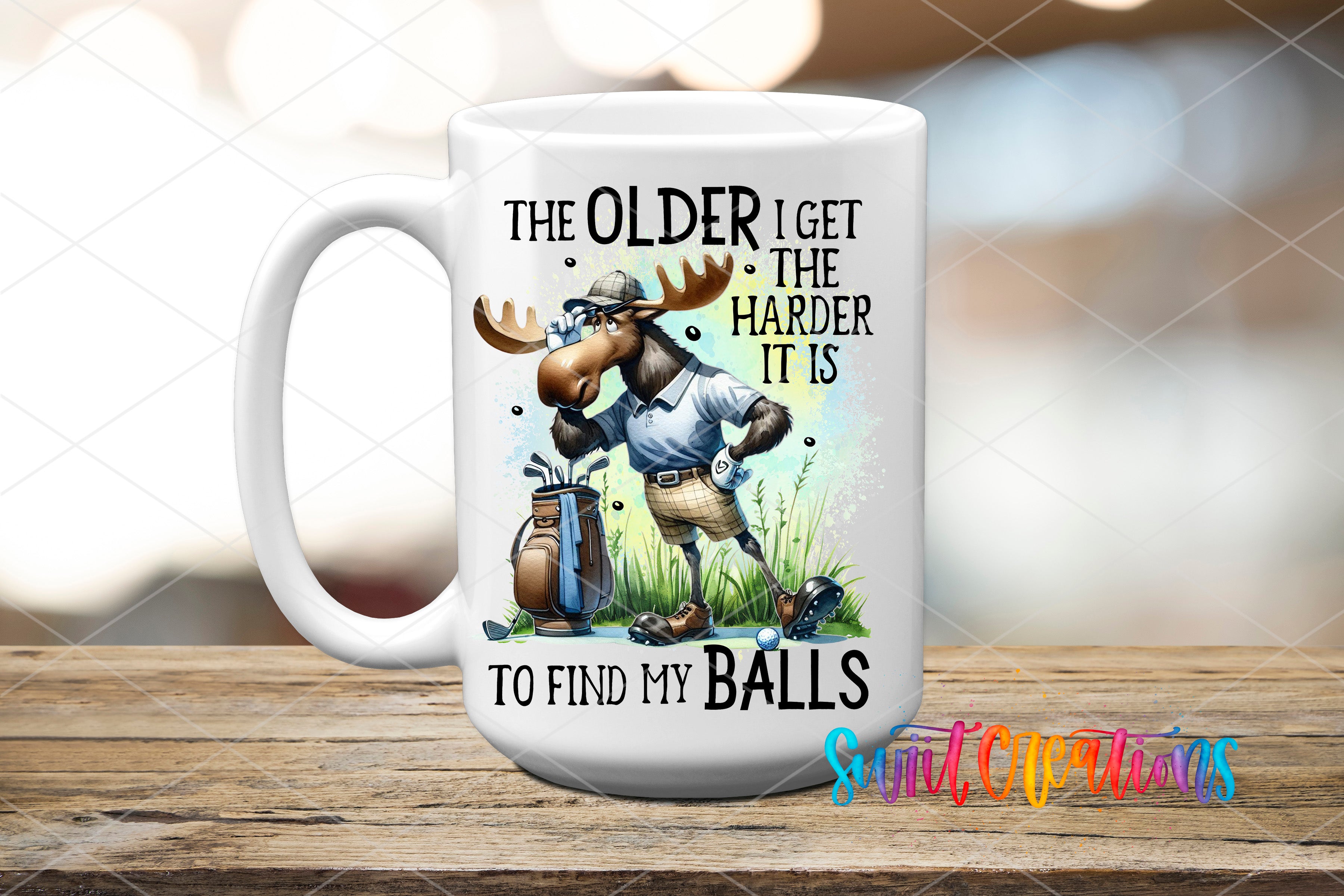A white ceramic mug with a cartoon moose holding a golf club and the text "The older I get, the harder it is to find my balls" printed on it.
