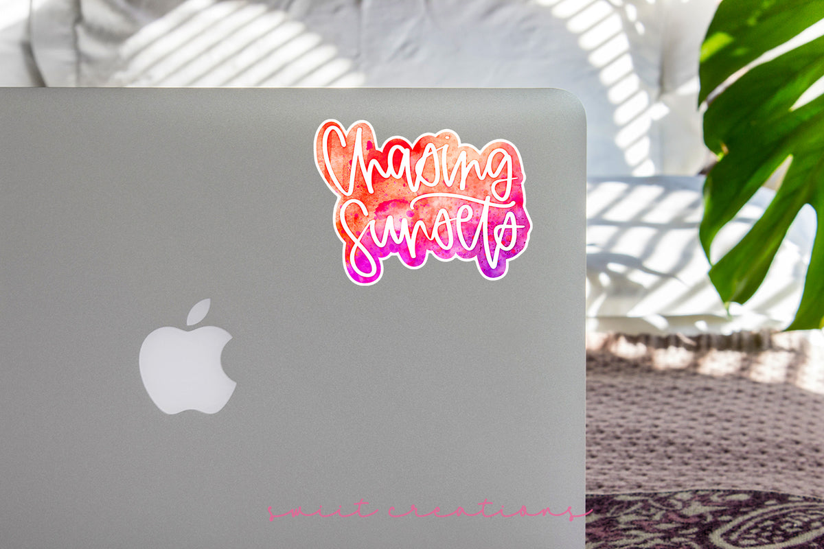 Chasing Sunsets sticker on the lid of a silver laptop