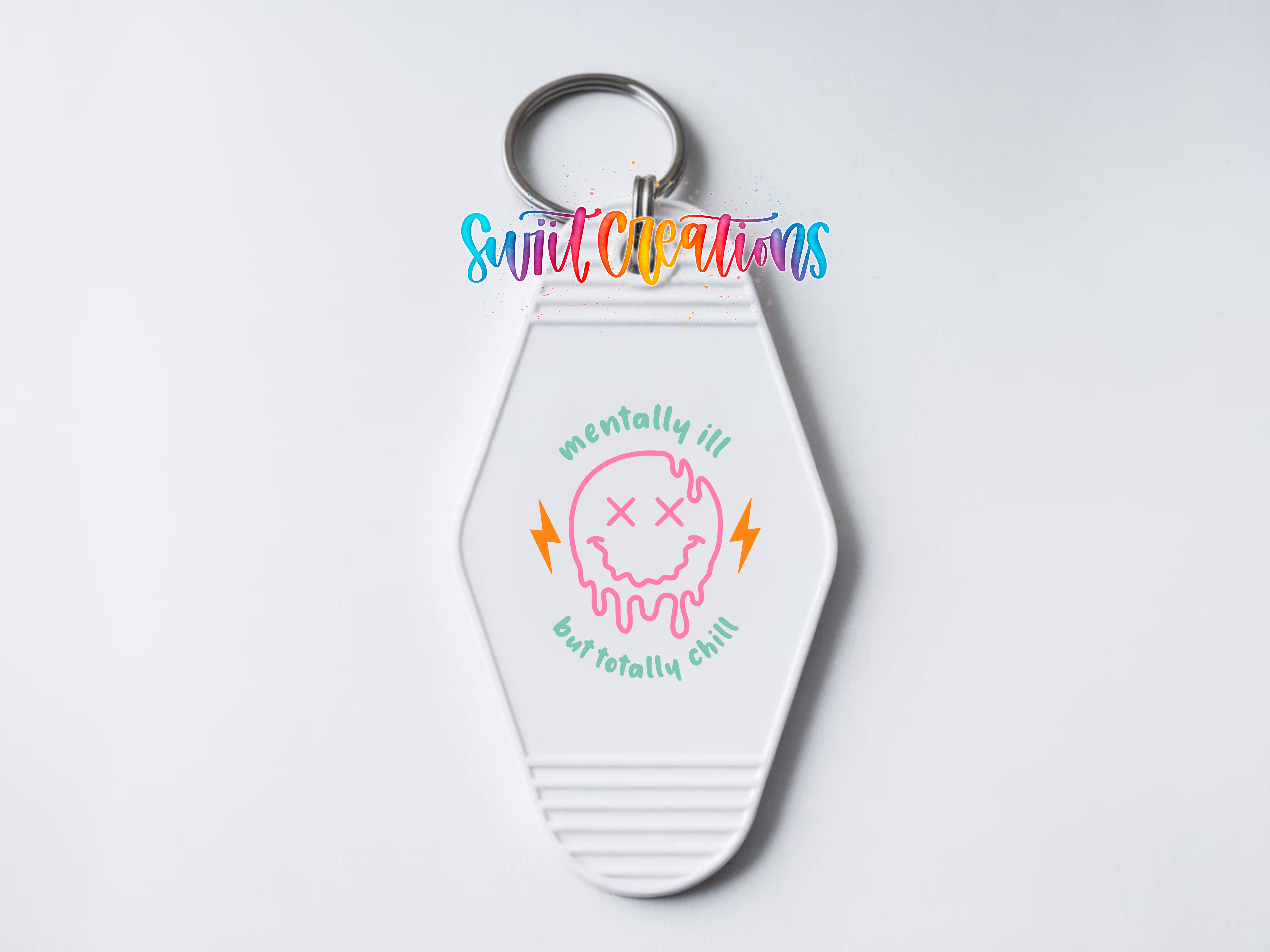 A keychain with a colorful design featuring a dripping, dripping face and the text "mentally ill butototally chill" printed on it.