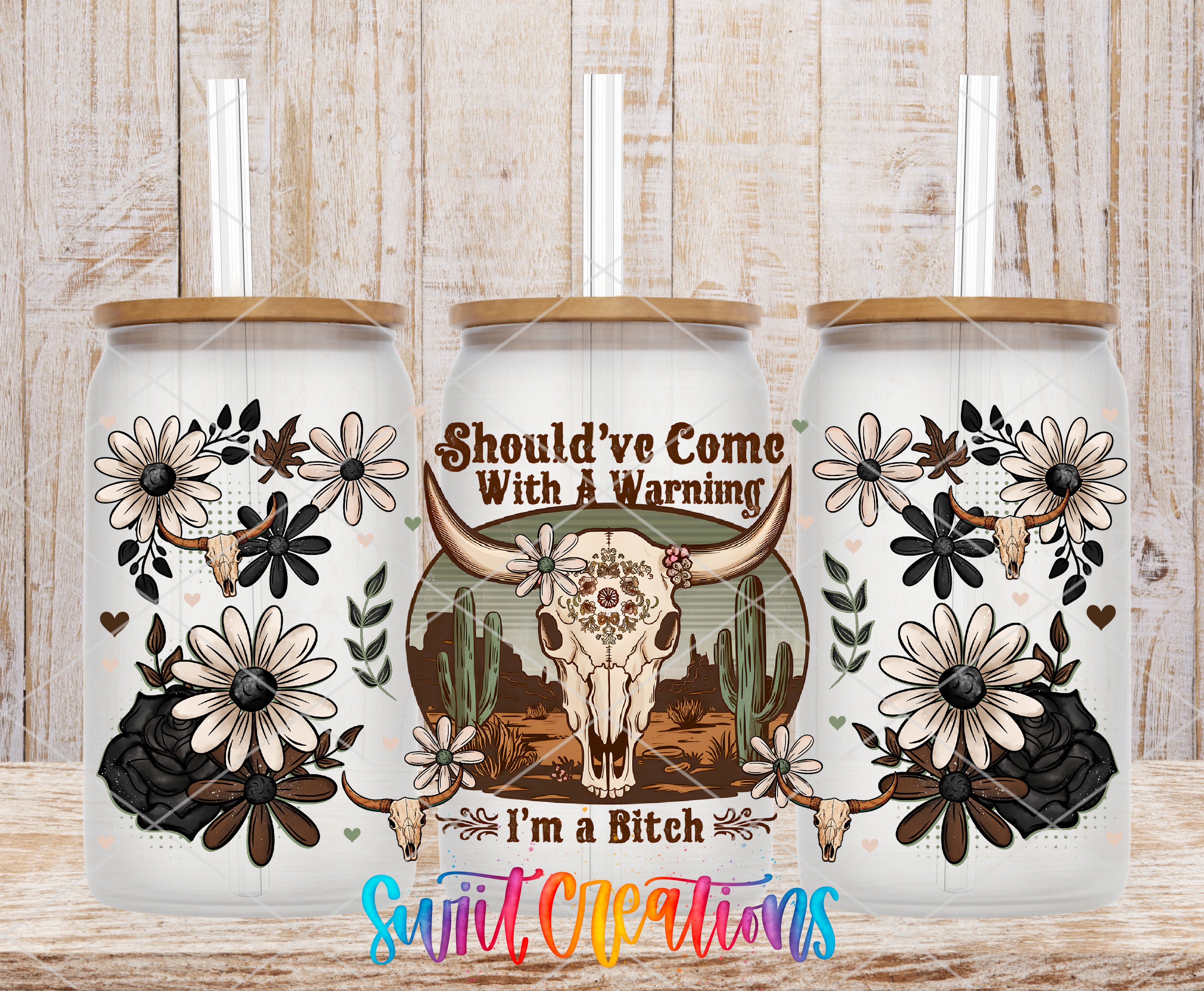 A collage of three white ceramic tumblers with floral and skull designs, along with the text "ShOULD'VE COME WITH A WARNING I'M A BITCH" and a colorful watermark.