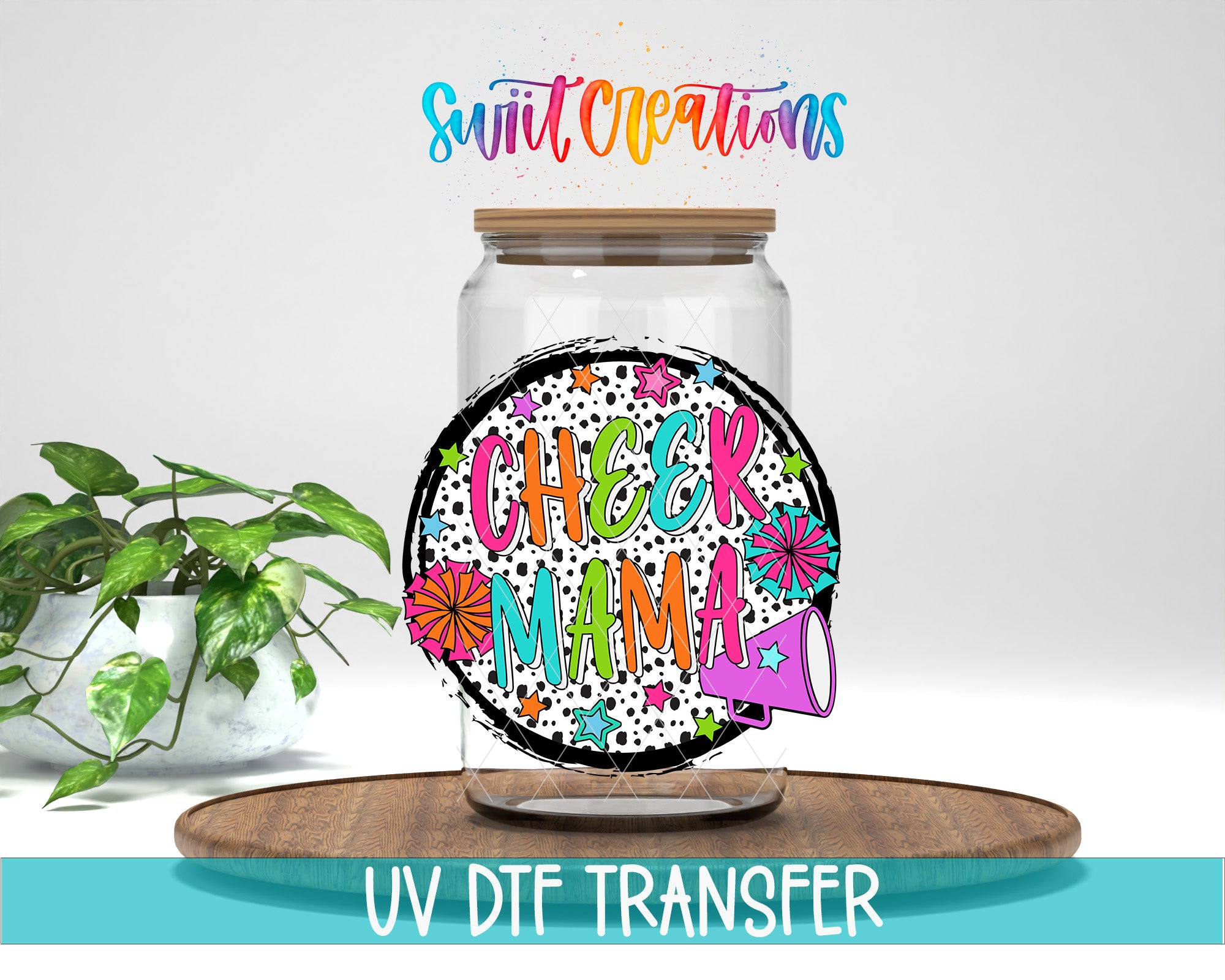 a glass jar with a colorful, hand-drawn design on it, placed on a wooden surface. The jar has a lid and is surrounded by a potted plant. The text "Swift Creations" is written above the jar, and "CHEER MAMA" is written on the jar itself. The image also includes the text "UV DFT TRANSFER" at the bottom.