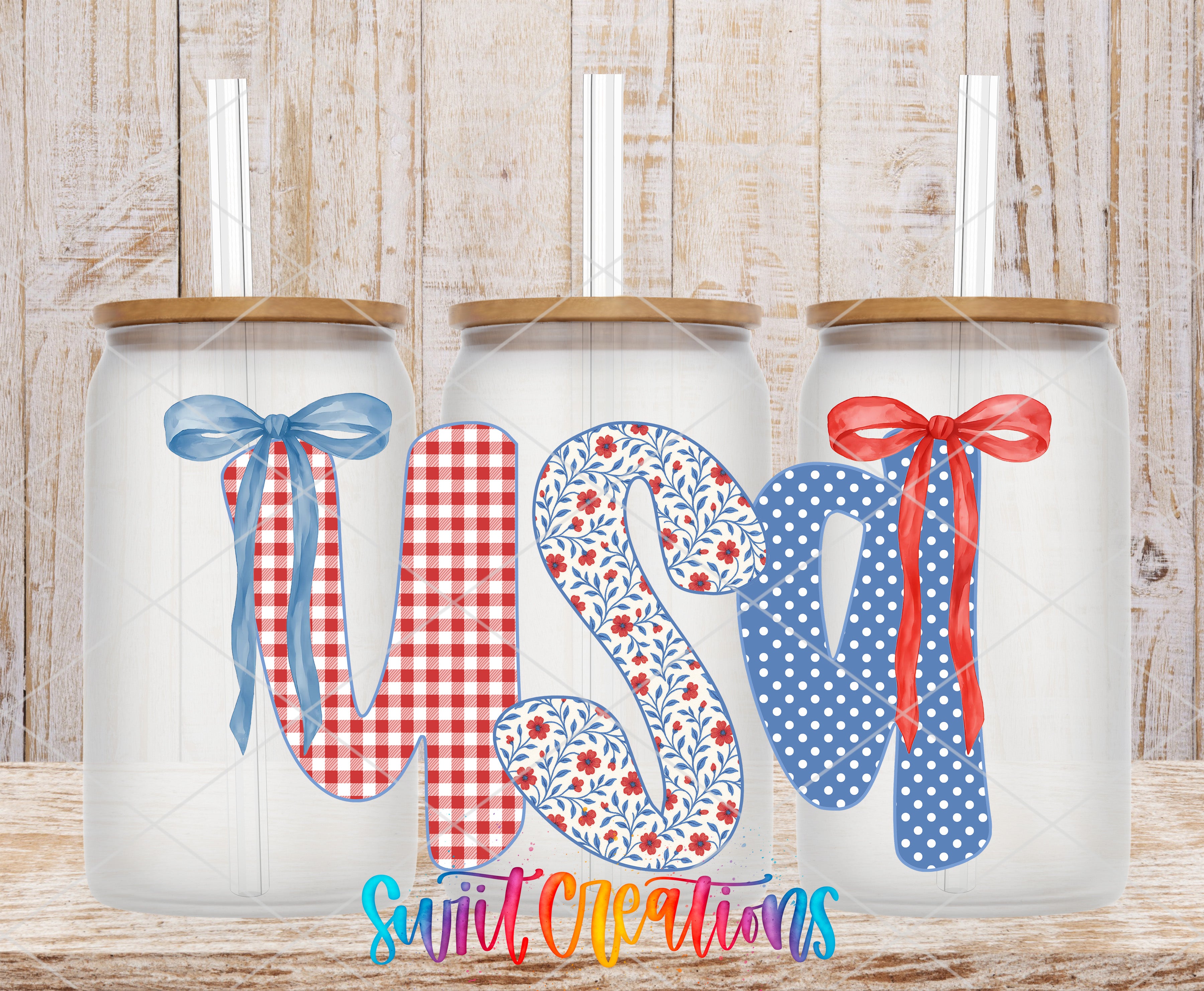 Three glass jars with ribbons and bows, each containing a straw, arranged in a row against a wooden background.