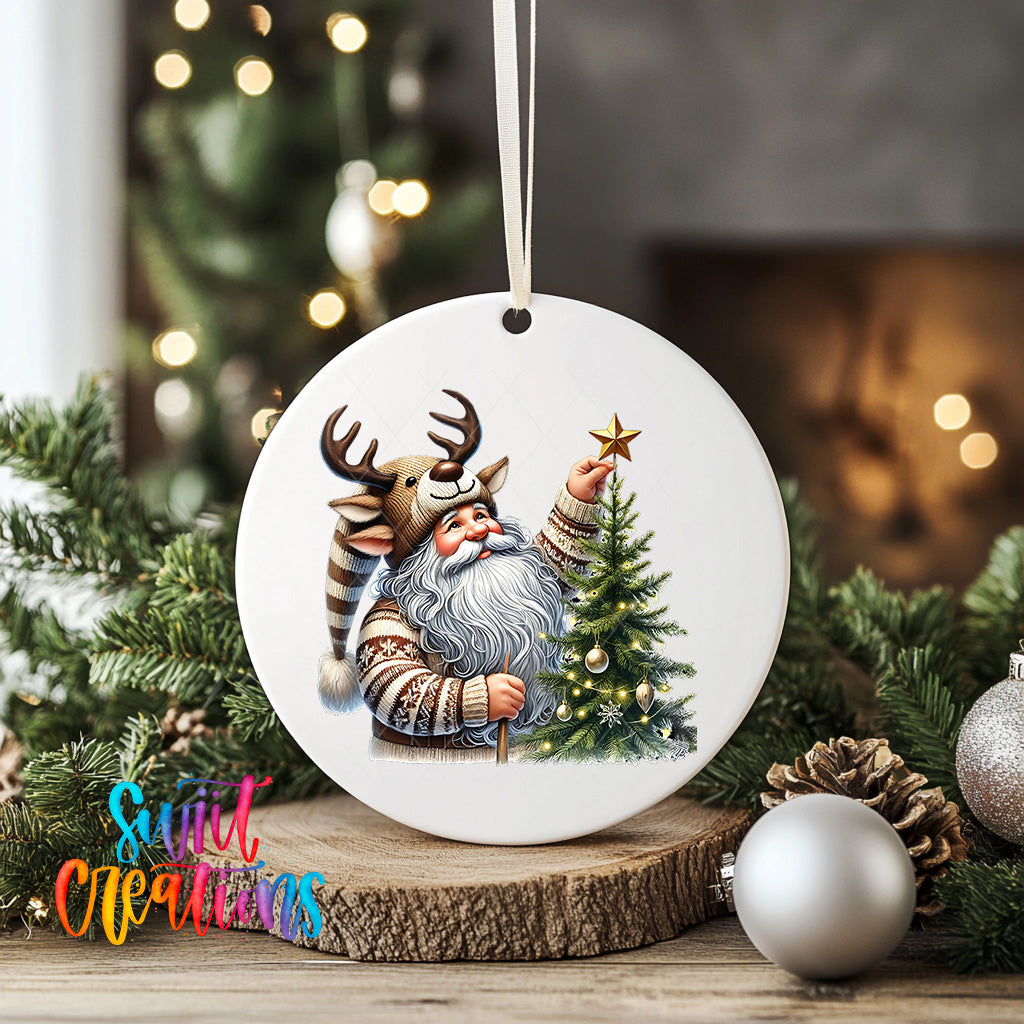 A white ceramic ornament featuring a Santa Claus figure holding a star on a Christmas tree, surrounded by pine branches and ornaments.