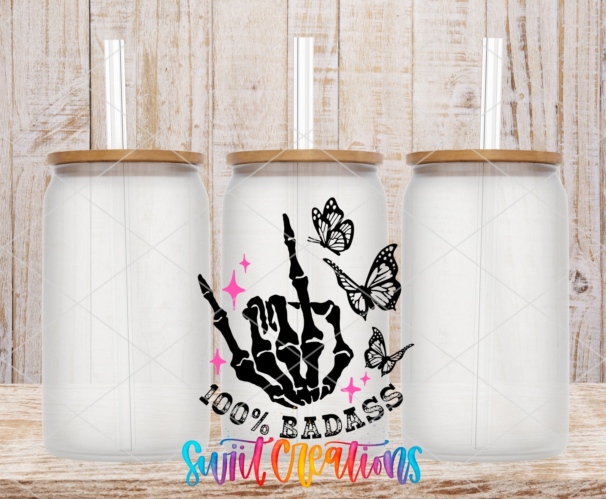 100% Badass UV DTF transfer applied to a clear glass can set from Swiit Creations