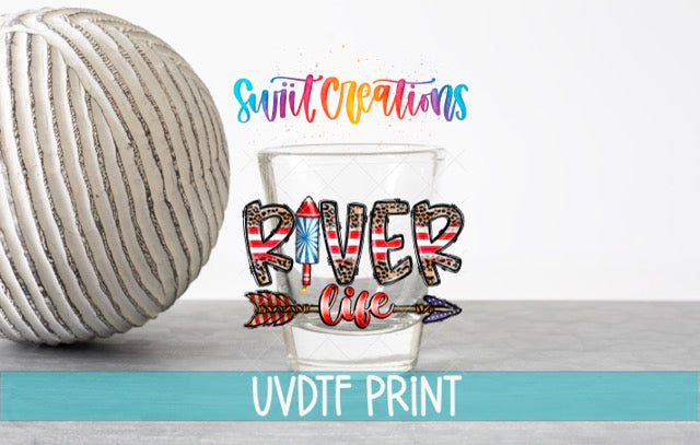 a ball of yarn next to a shot glass