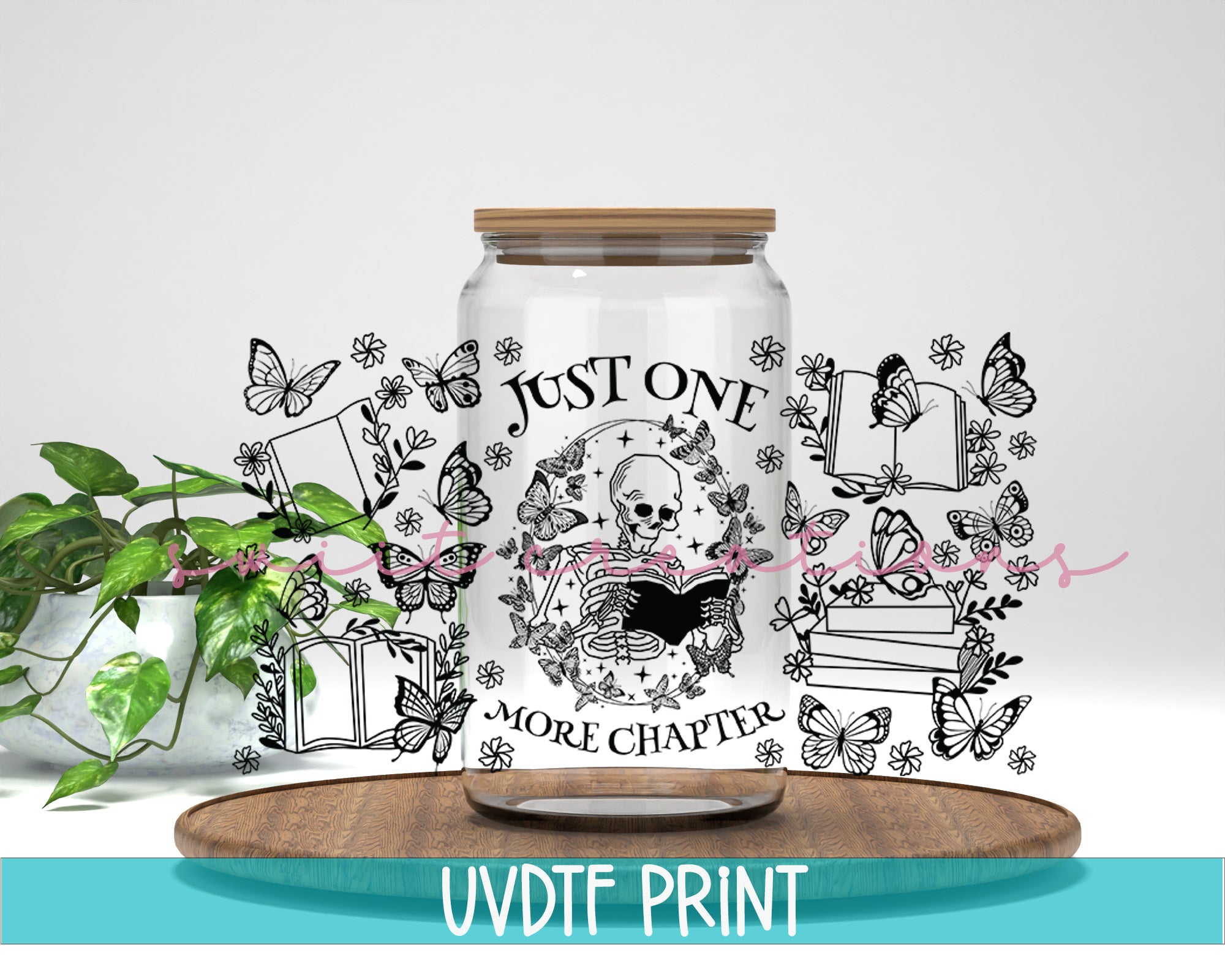 a jar with a picture of a cat on it next to a potted plant