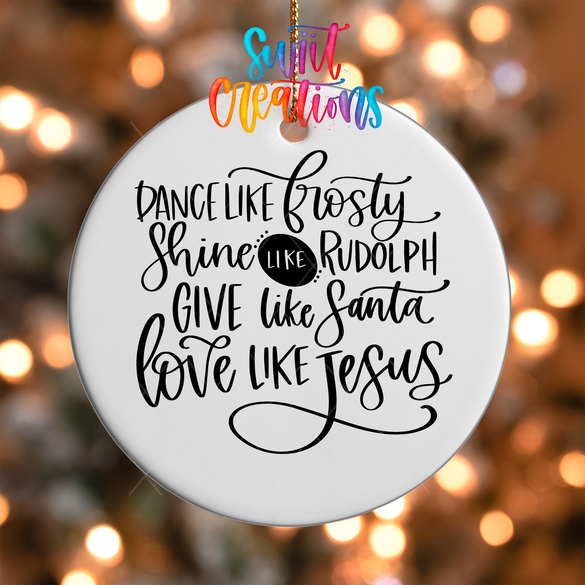 a white ornament with black text that reads "Dance like Frosty, Shine like Rudolph, Give like Santa, Love like Jesus".