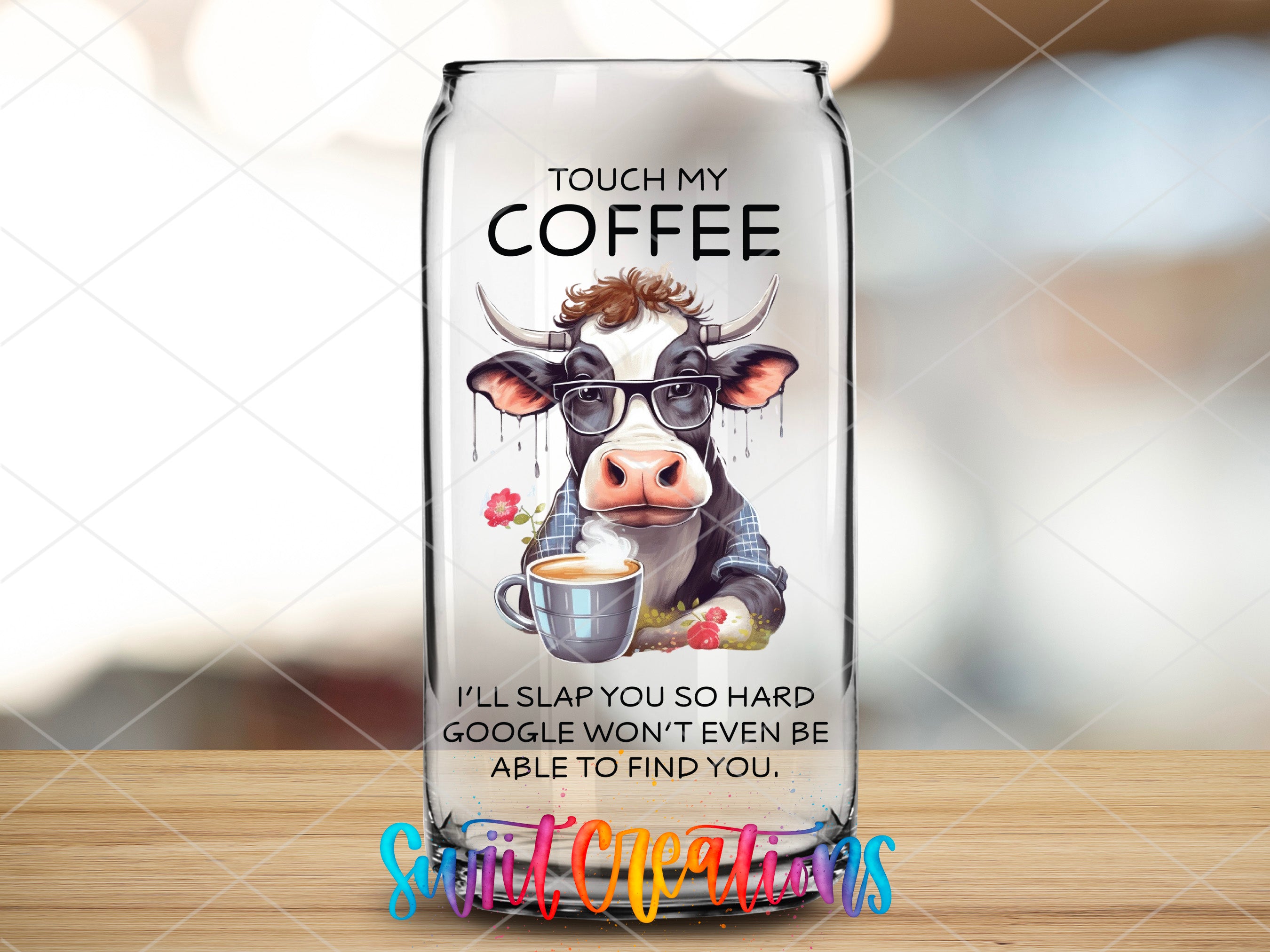 a glass bottle with a picture of a cow on it