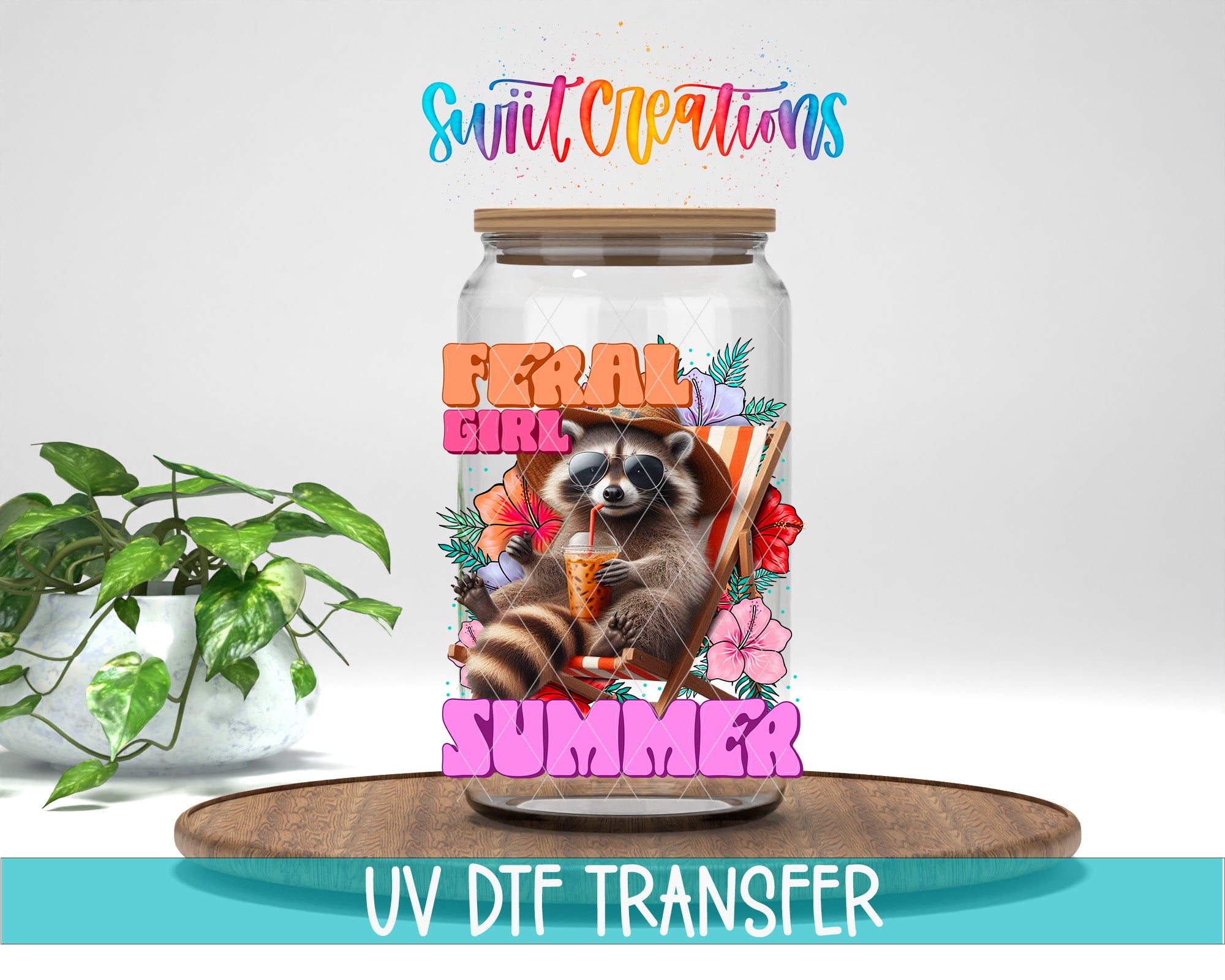 a glass jar with a raccoon and the text "Feral Girl Summer" printed on it, along with a plant and a wooden tray.