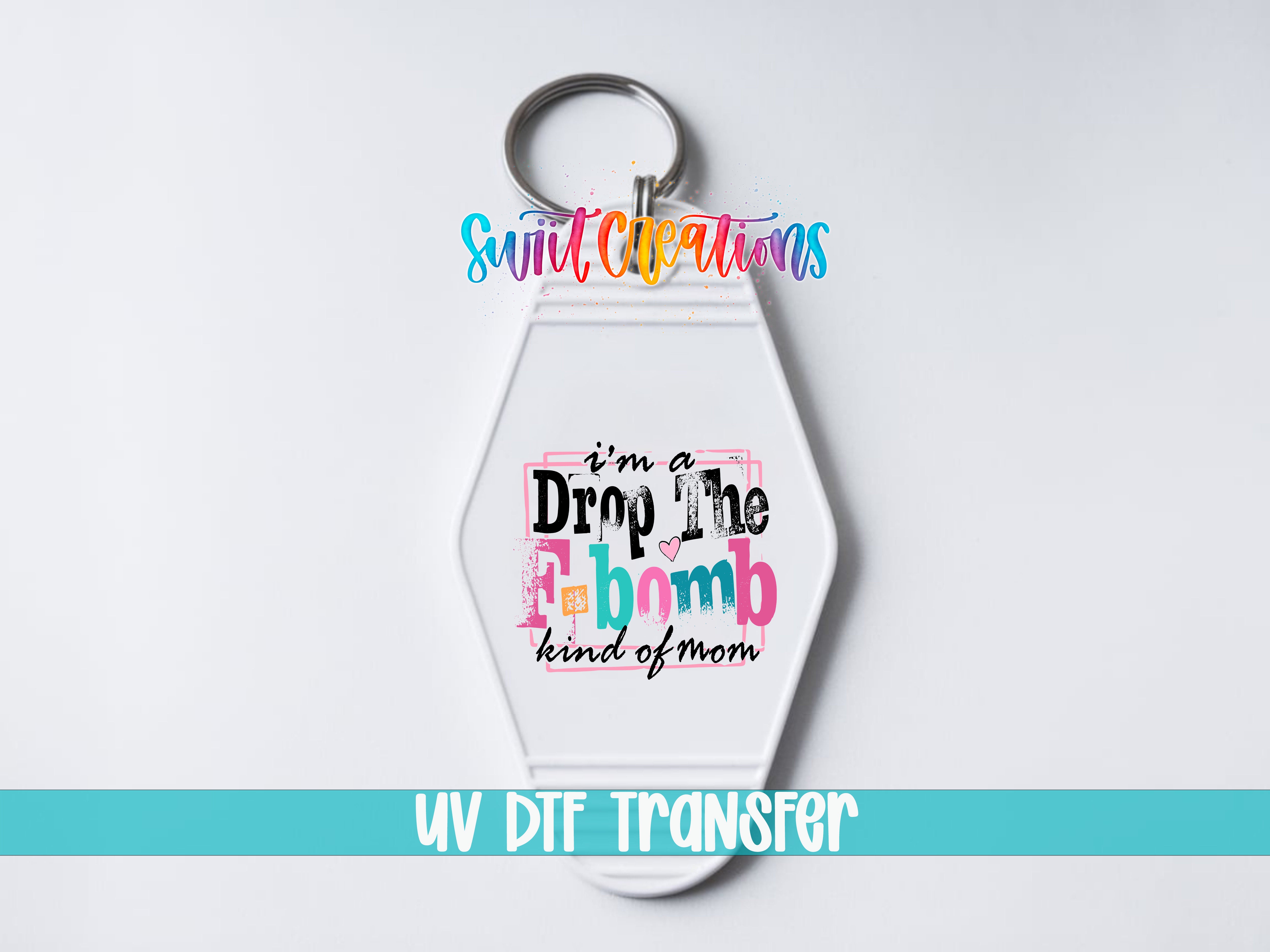 A keychain with a colorful design and text on it, along with the text "UV DDF Transfer" at the bottom.