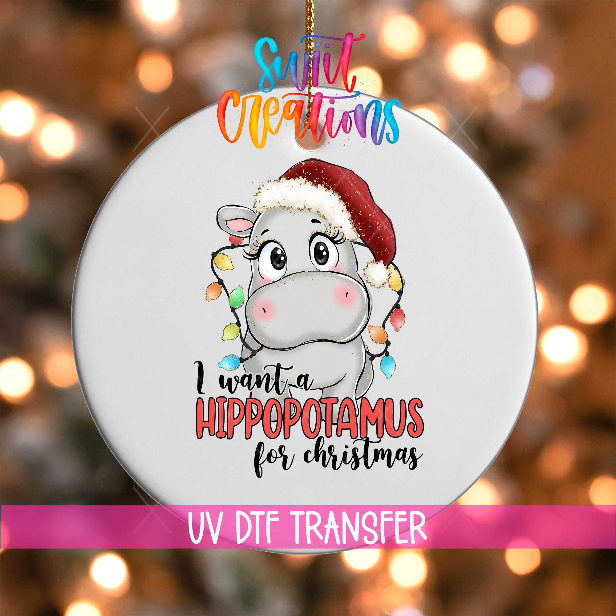 A white ornament with a cartoon image of a hippopotamus wearing a Santa hat and the text "I want a Hippopotamus for Christmas" printed on it.