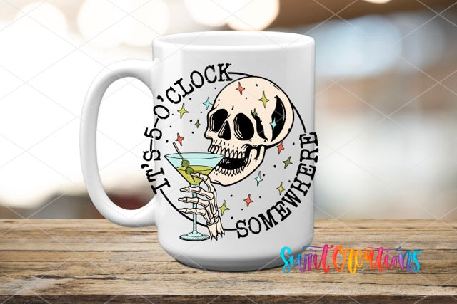 a white coffee mug with a skeleton holding a martini
