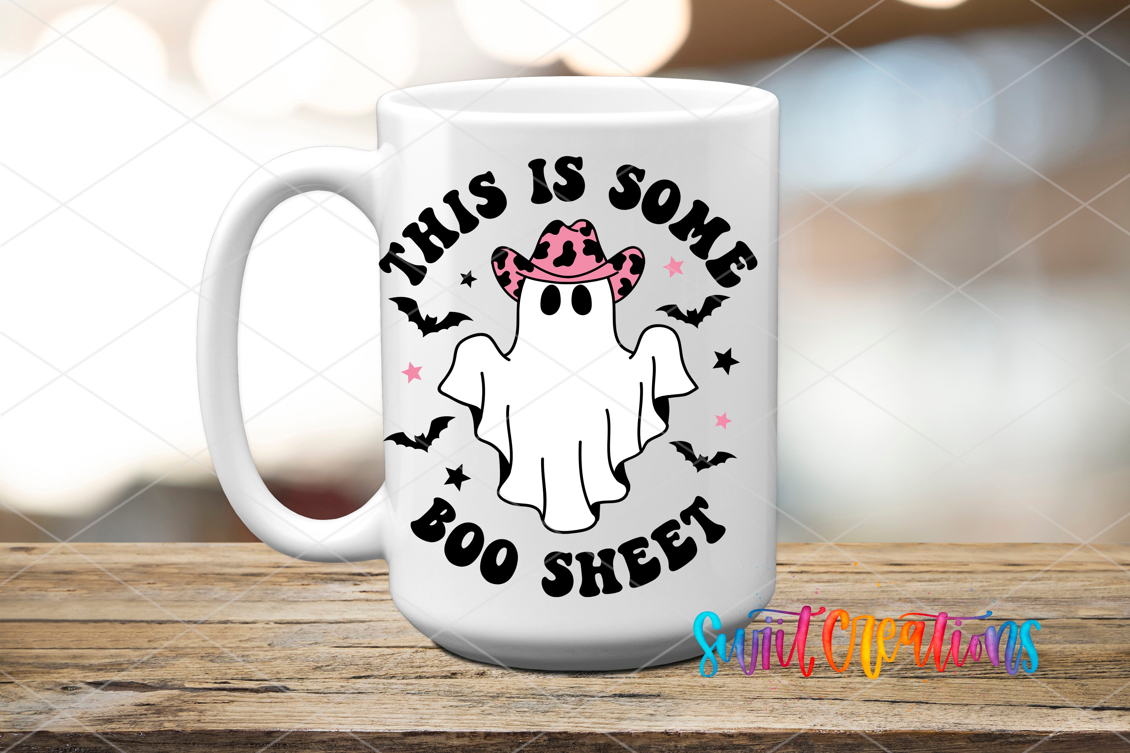 A white mug with a graphic design featuring a ghost wearing a cowboy hat and the text "This is some BOO sheet" printed on it.