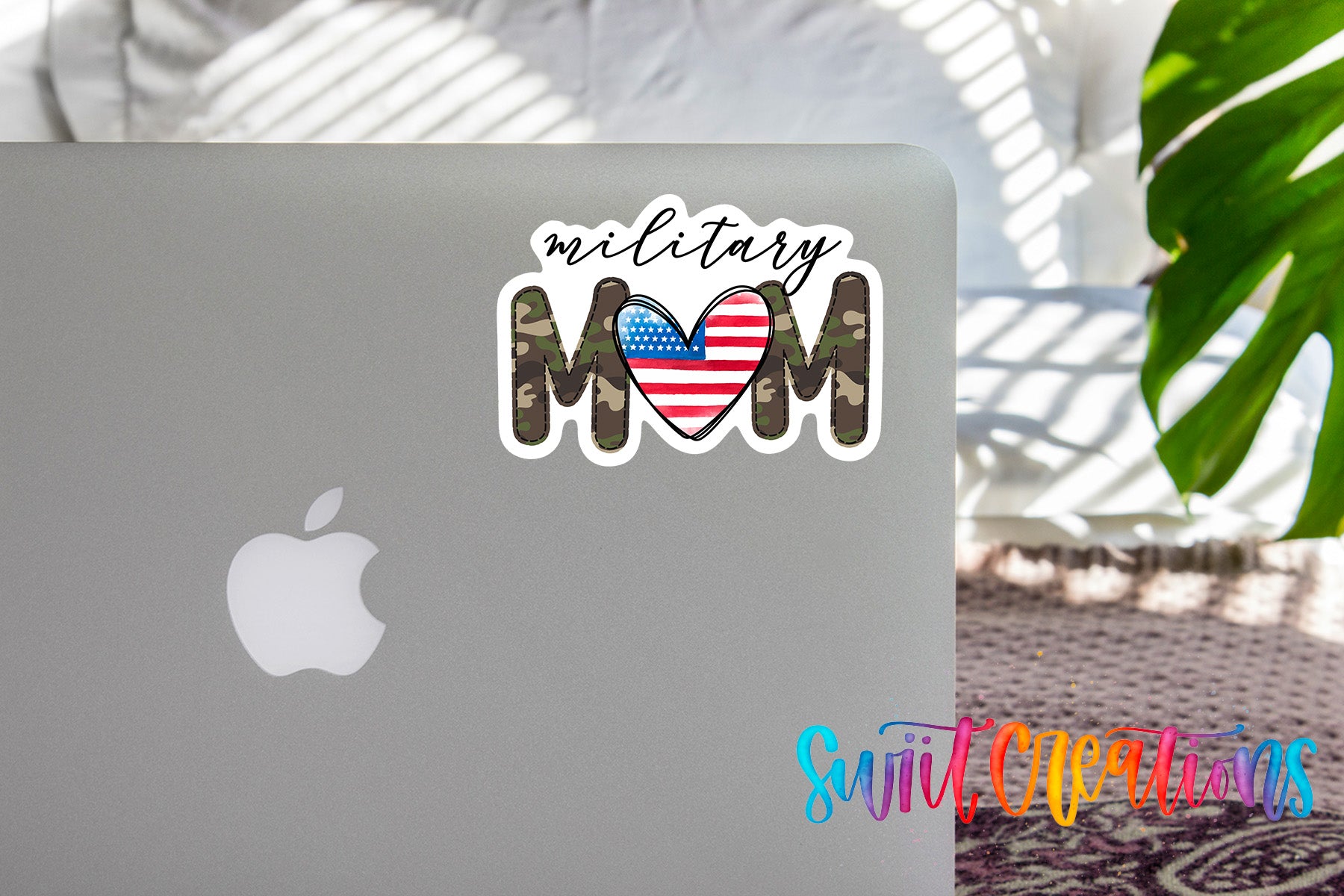 a sticker with the text "Military Mom" and an American flag design on the back of a laptop.