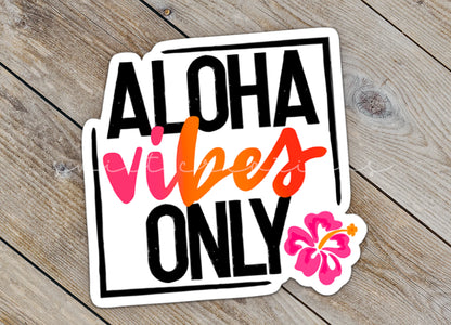 Close-up of the Aloha Vibes Only sticker on rustic wood