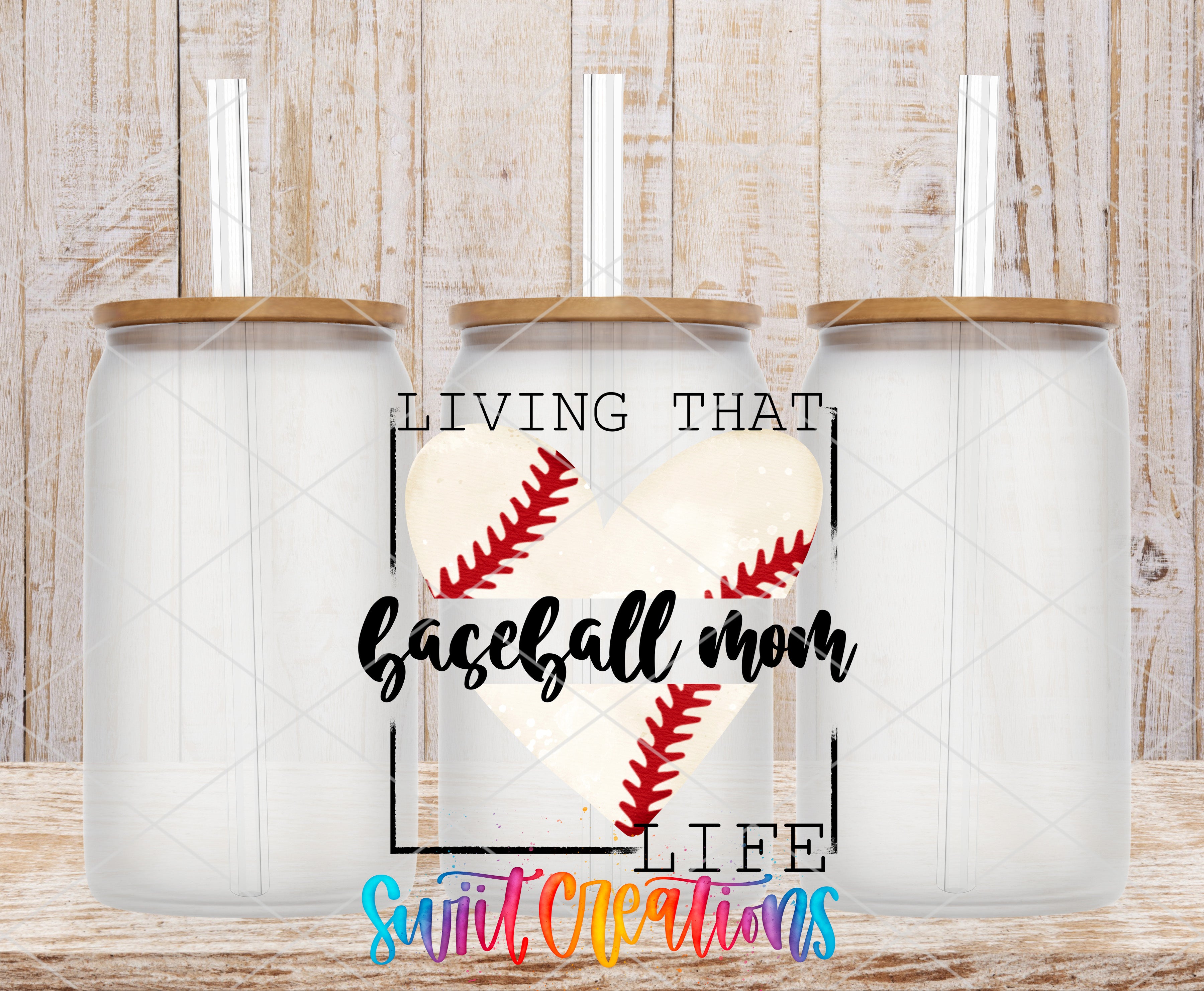 three glass jars with lids, each containing a straw, arranged in a row against a wooden background. The jars are labeled with the text "LIVING THAT BASEBALL MOM LIFE" and "Sweet Creations", suggesting a connection to the sport of baseball and the creator's business.