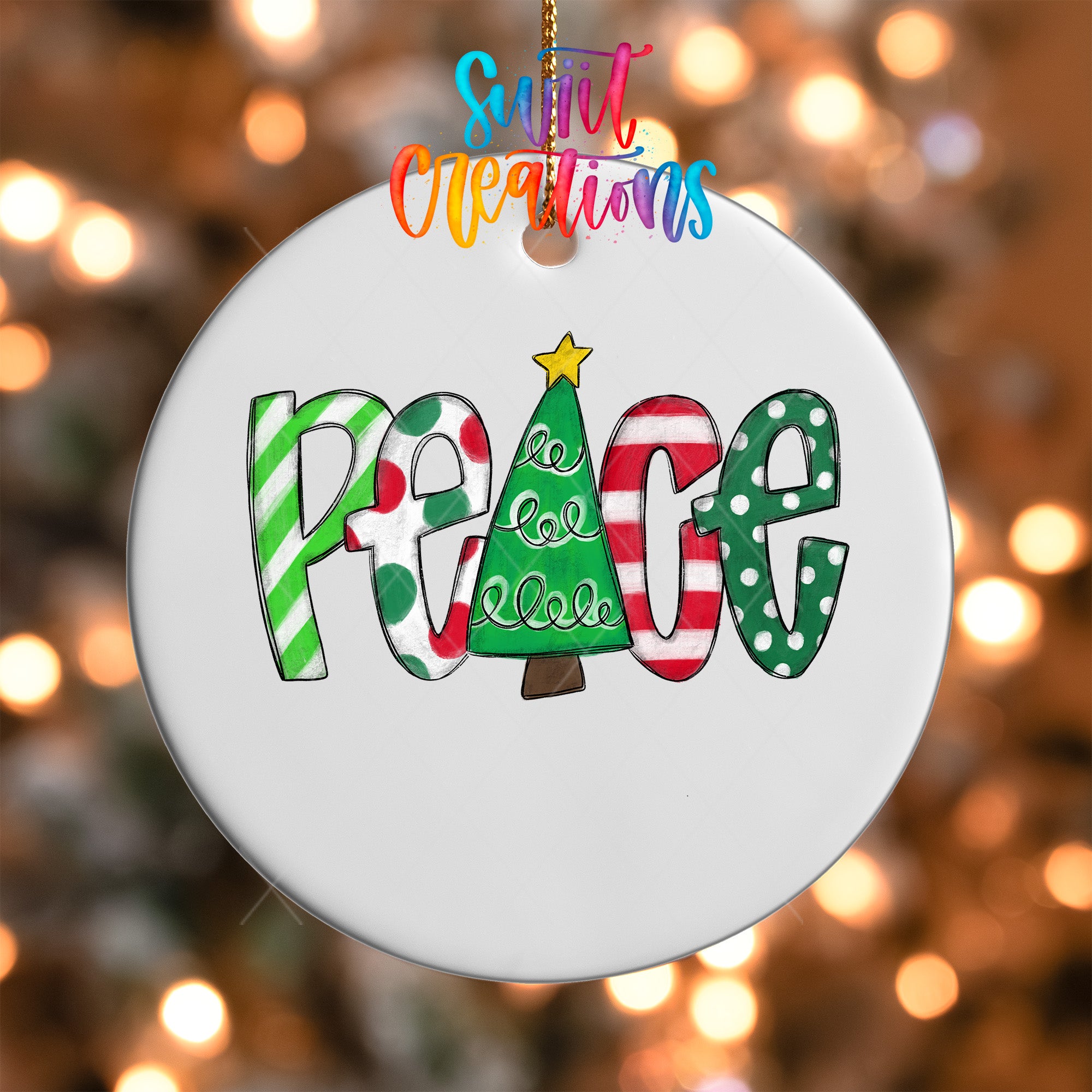 A white ornament with the word "Peace" written in colorful letters, featuring a Christmas tree design.