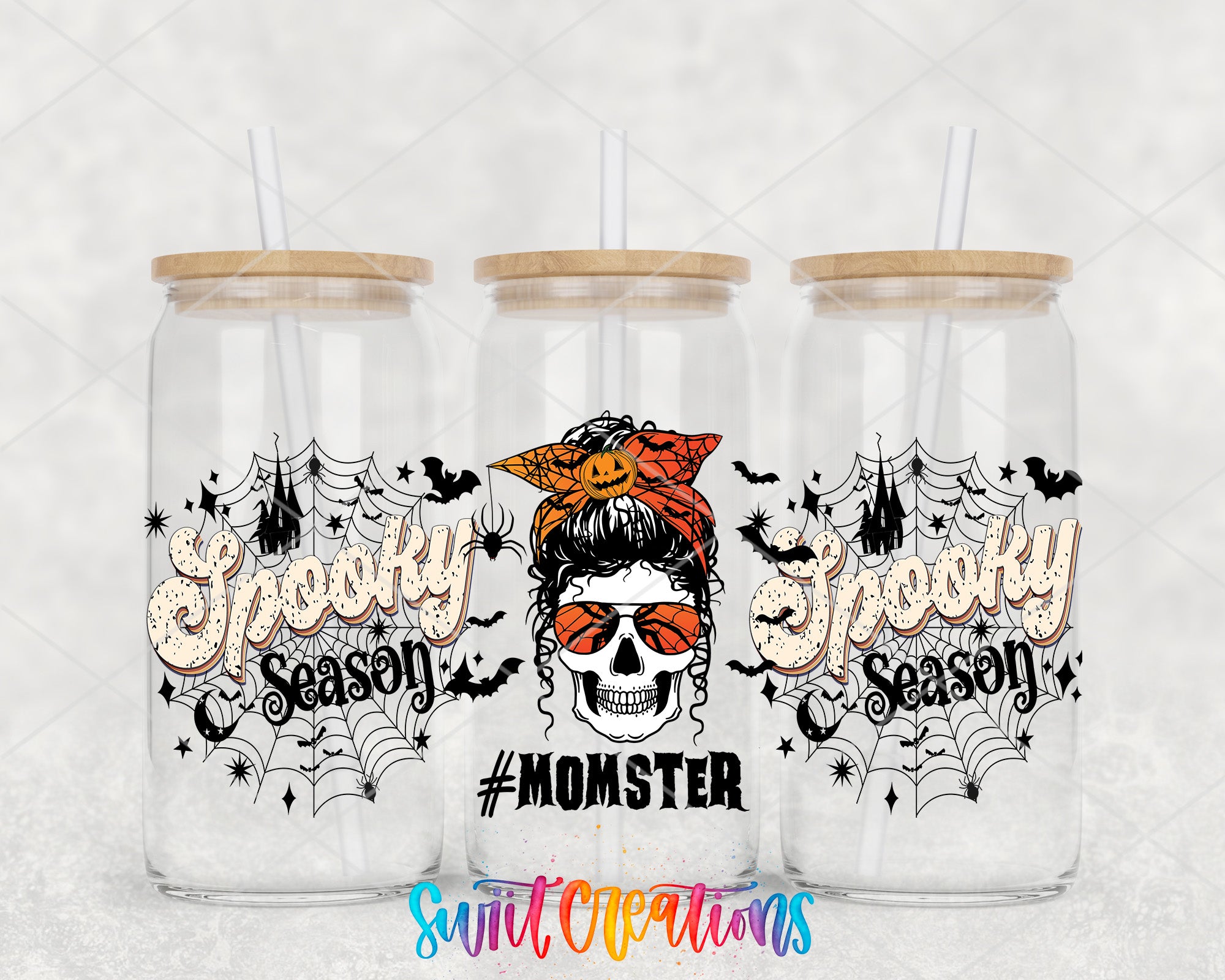 three glass jars with Halloween-themed designs and text.