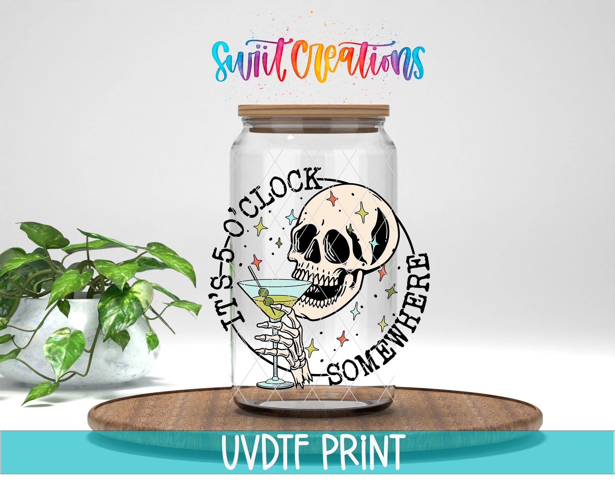 A glass jar with a skull and star design, along with the text "It's 5 o'clock somewhere" and "Someday somewhere" printed on it. The jar is placed on a wooden surface, and there is a potted plant in the background.