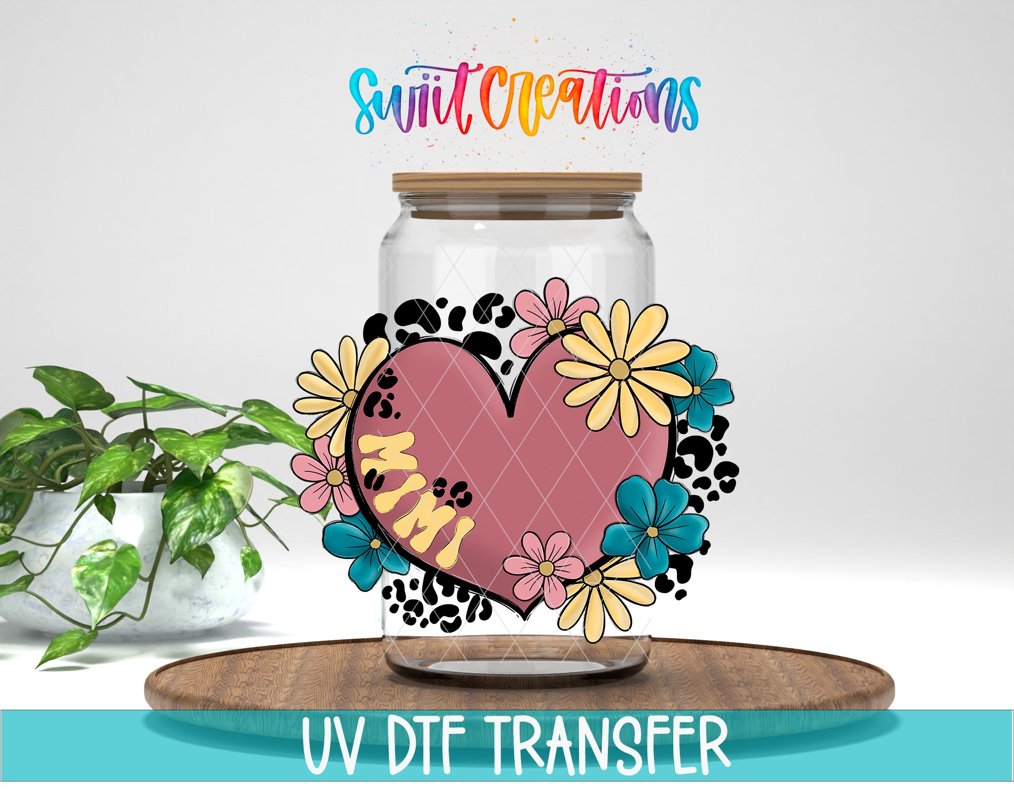 a glass jar with a heart-shaped design and colorful flowers, placed on a wooden surface.