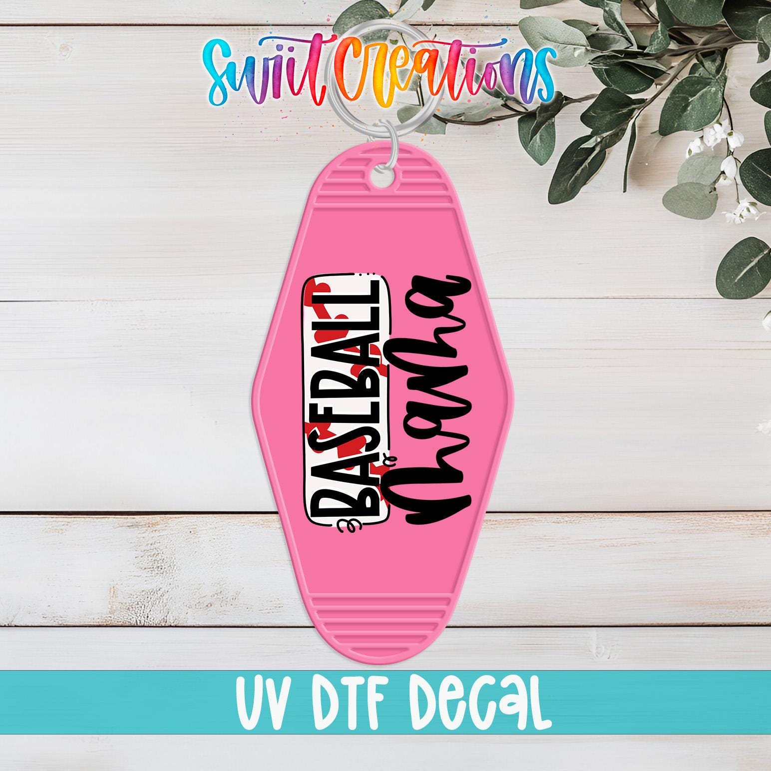 A pink keychain with the text "Baseball" printed on it, placed on a wooden surface with some greenery in the background.