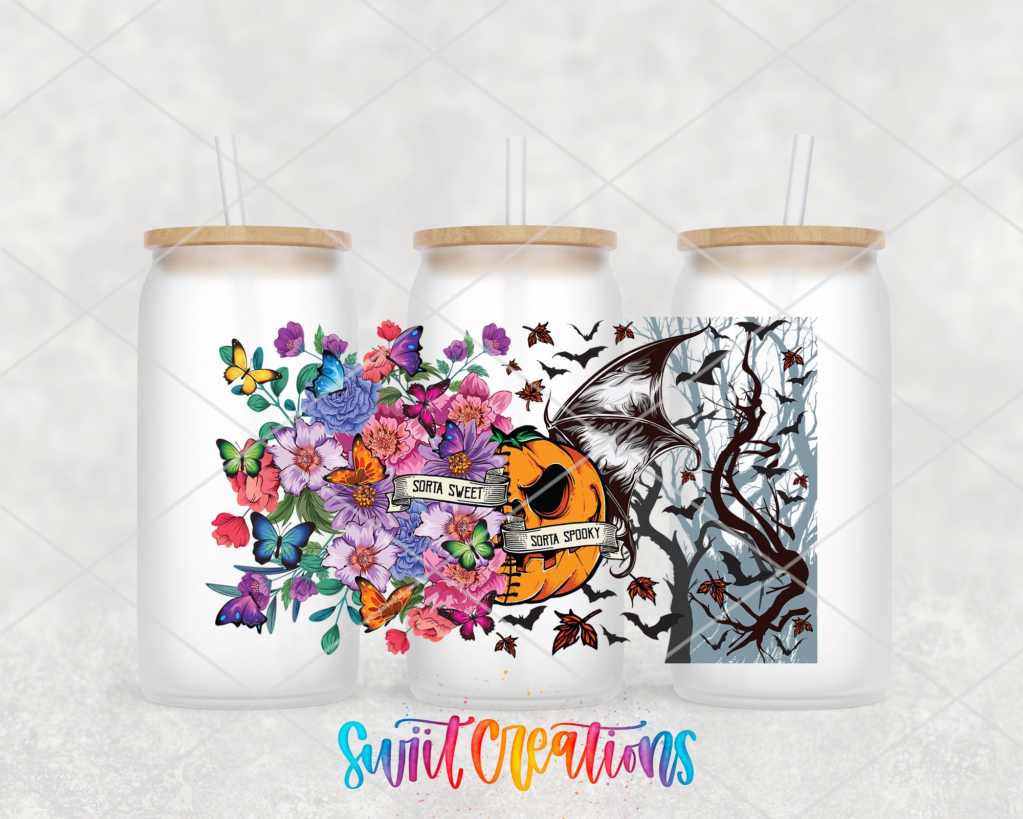 three white tumblers with colorful floral and spooky designs on them.