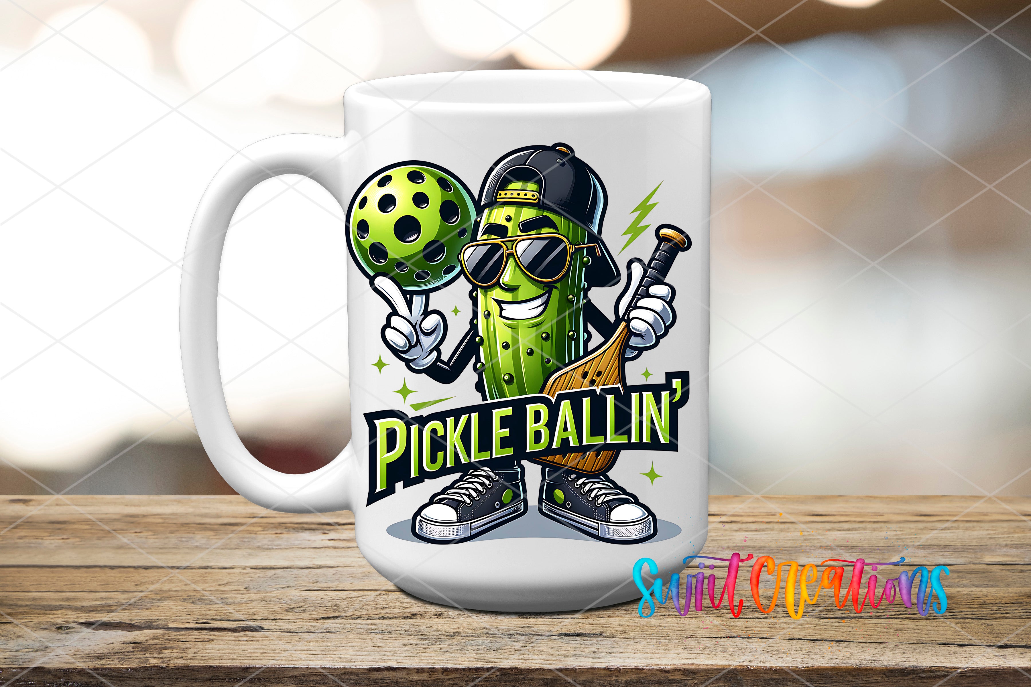 A white ceramic mug with a cartoon illustration of a pickle wearing sunglasses and holding a tennis racket, with the text "Pickle Ballin'!" printed on it.