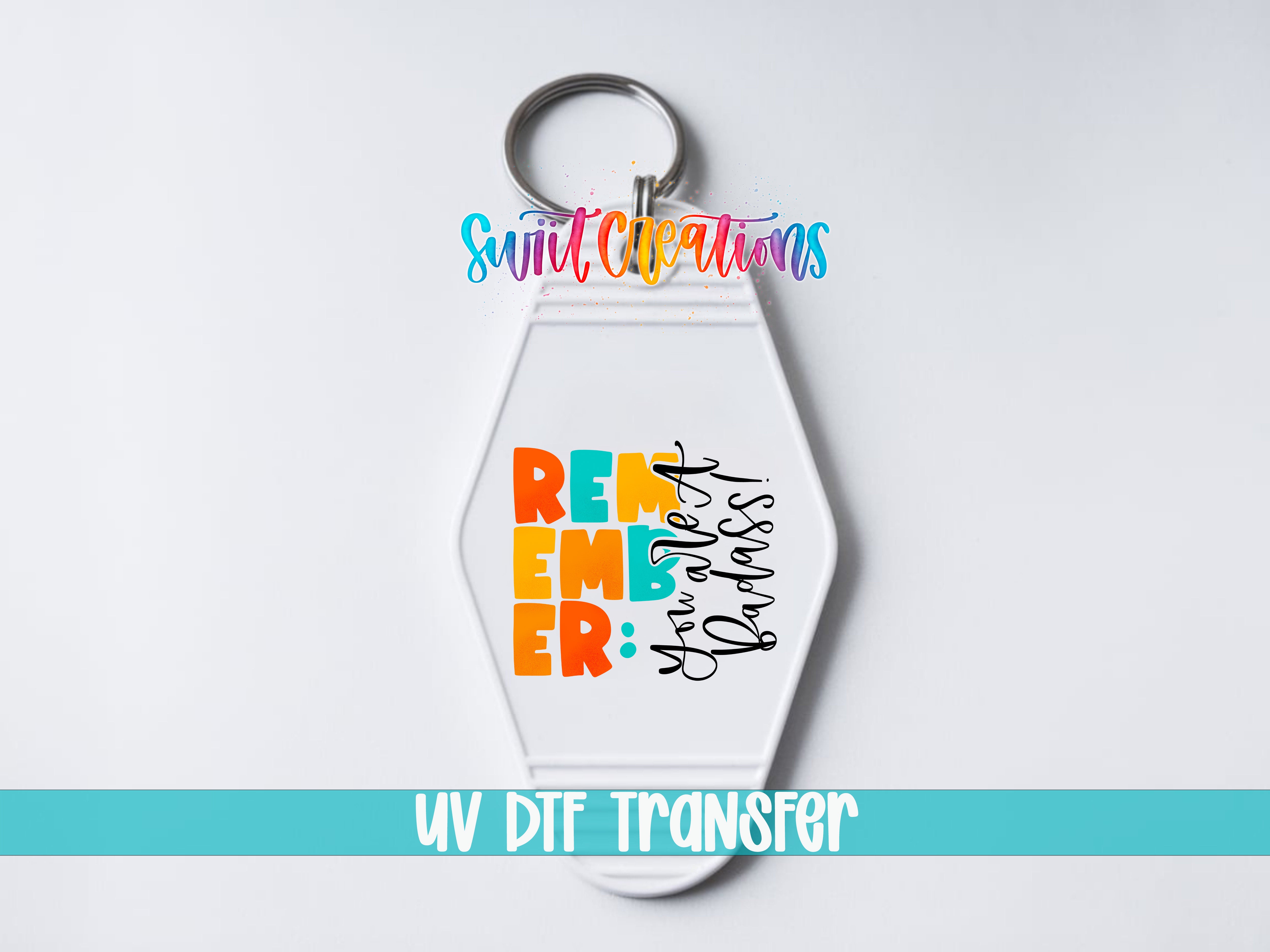 A keychain with a colorful design and text on it, along with the text "UV DDF Transfer" at the bottom.
