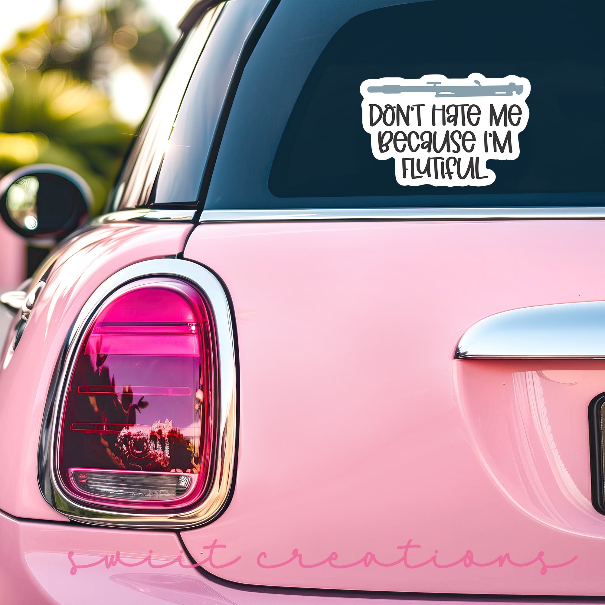 a pink car with a sticker that says don't hate me because i
