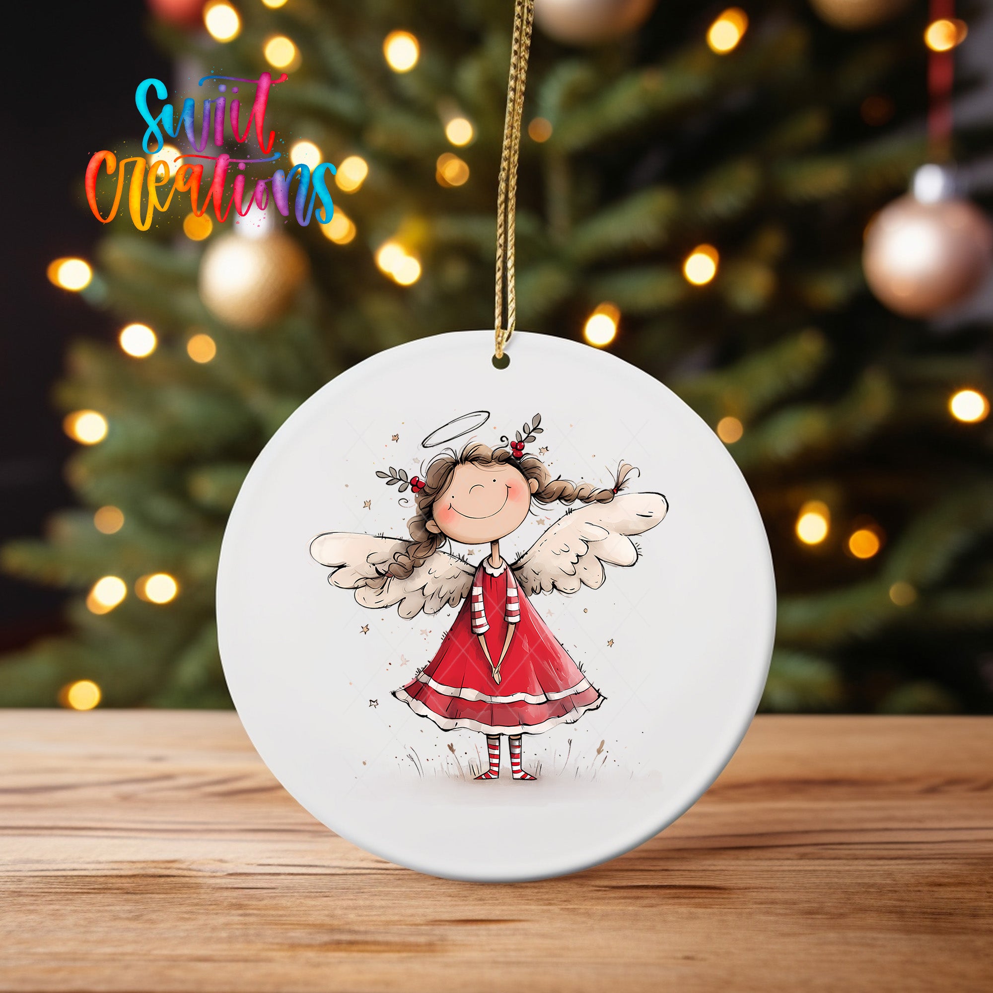 A white ceramic ornament featuring a smiling girl with angel wings, set against a blurred background of Christmas lights.