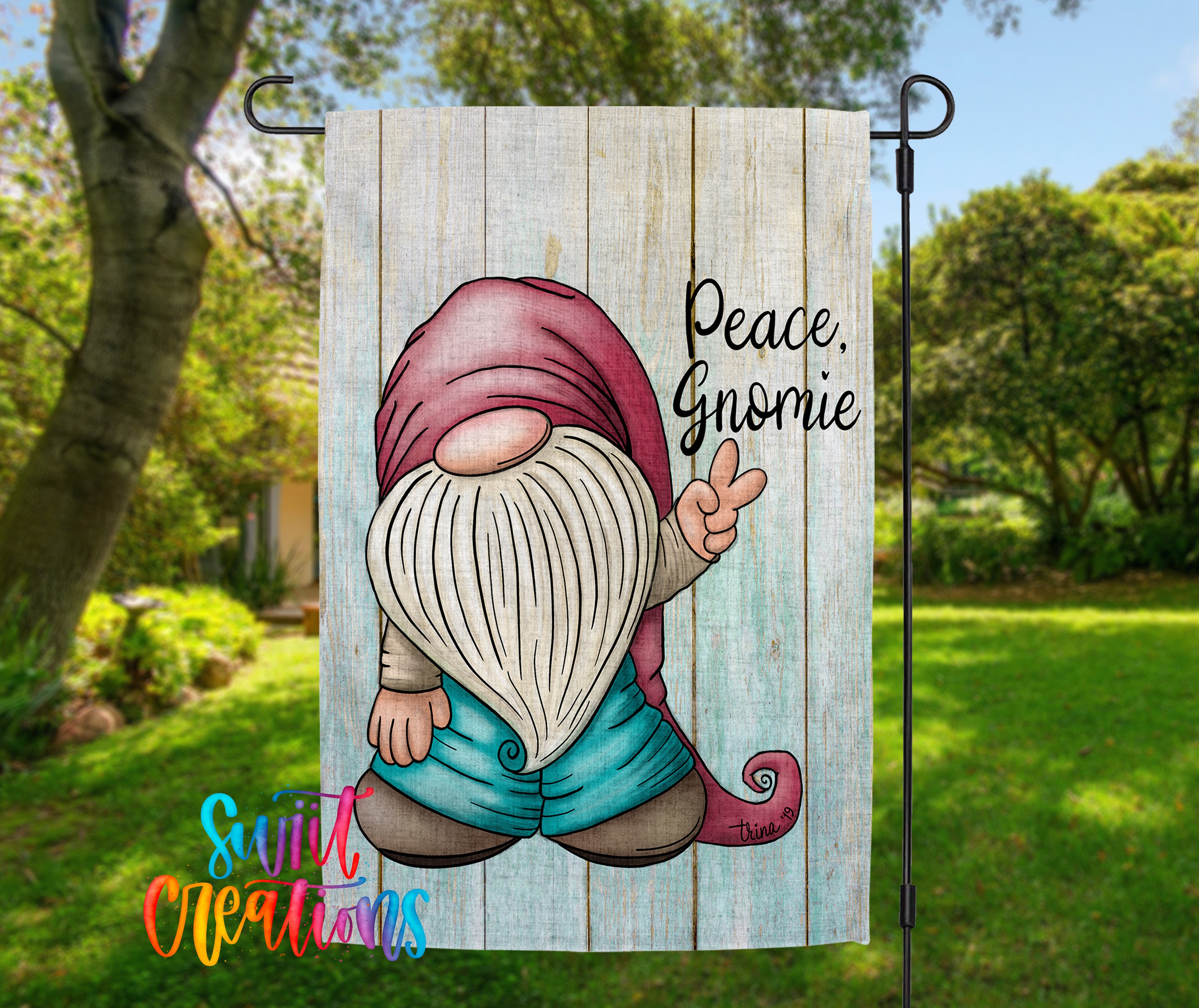 A garden gnome sign with the text "Peace. Gnomeie" is displayed in a garden setting with trees and greenery in the background.