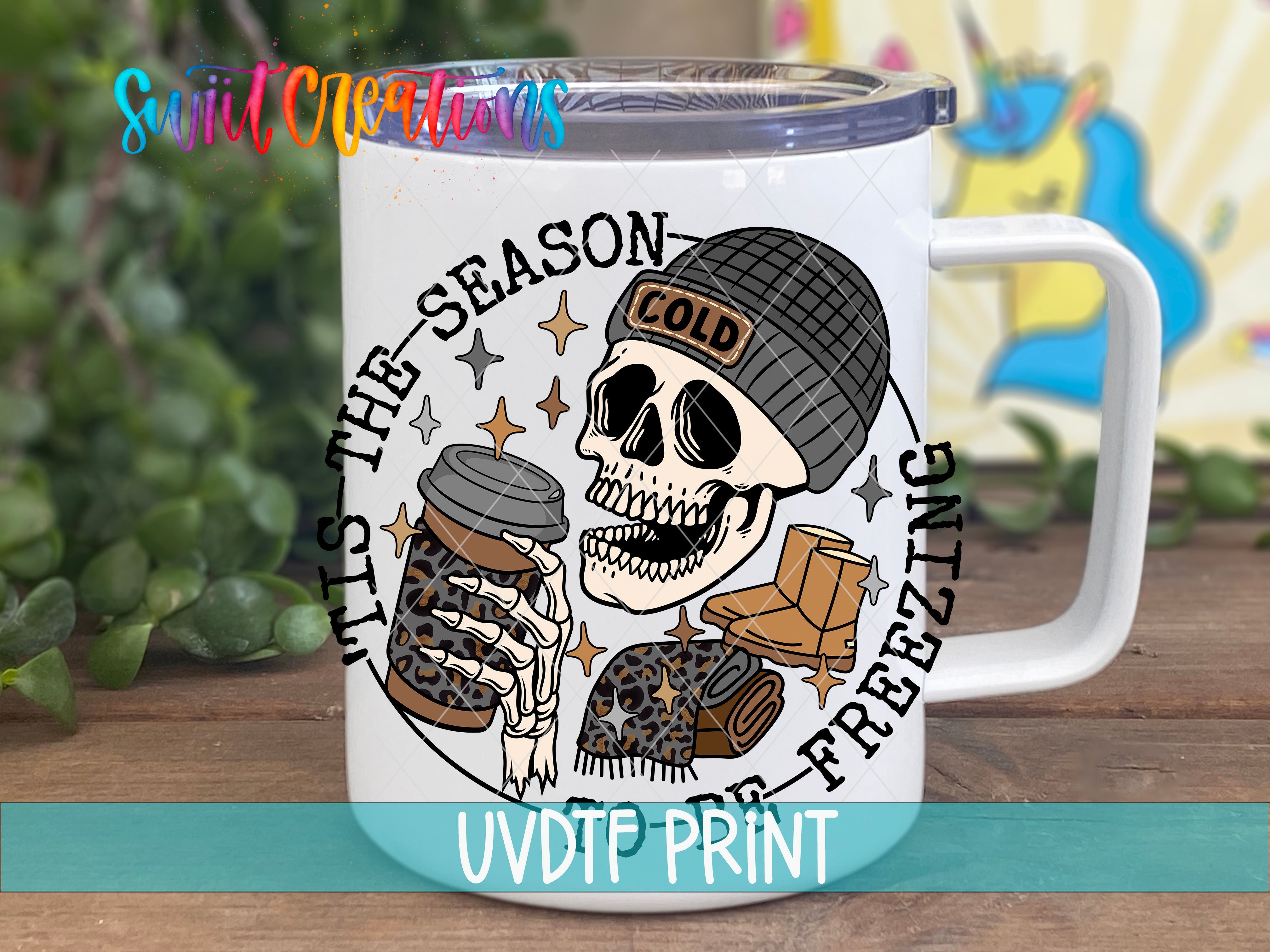 a white coffee mug with a skull wearing a beanie