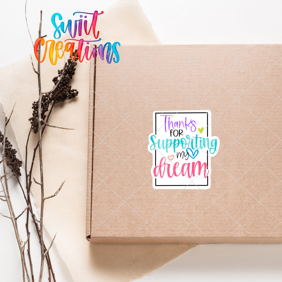 a box with a sticker on it next to a plant