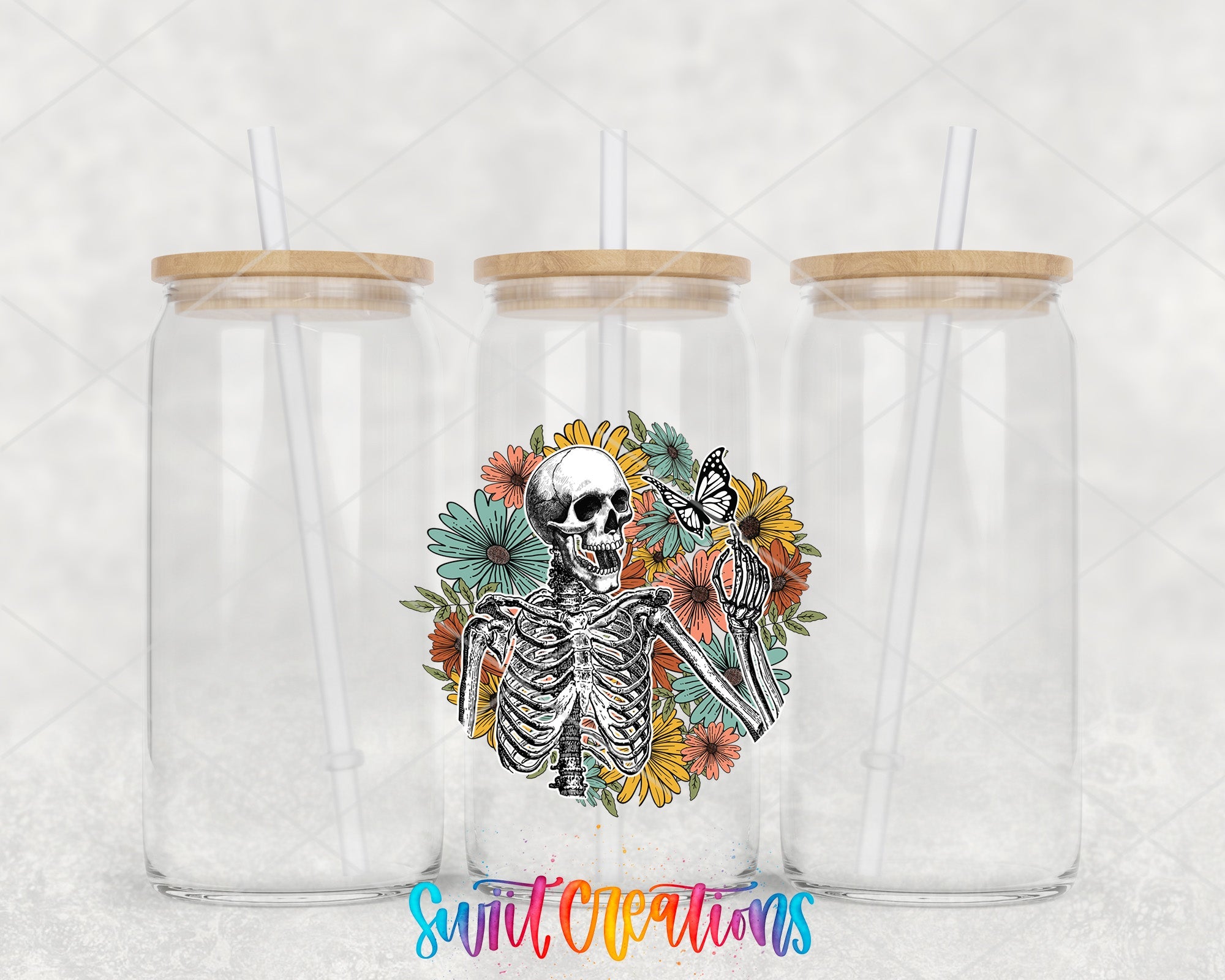 two clear tumblers with a skeleton and flowers on them