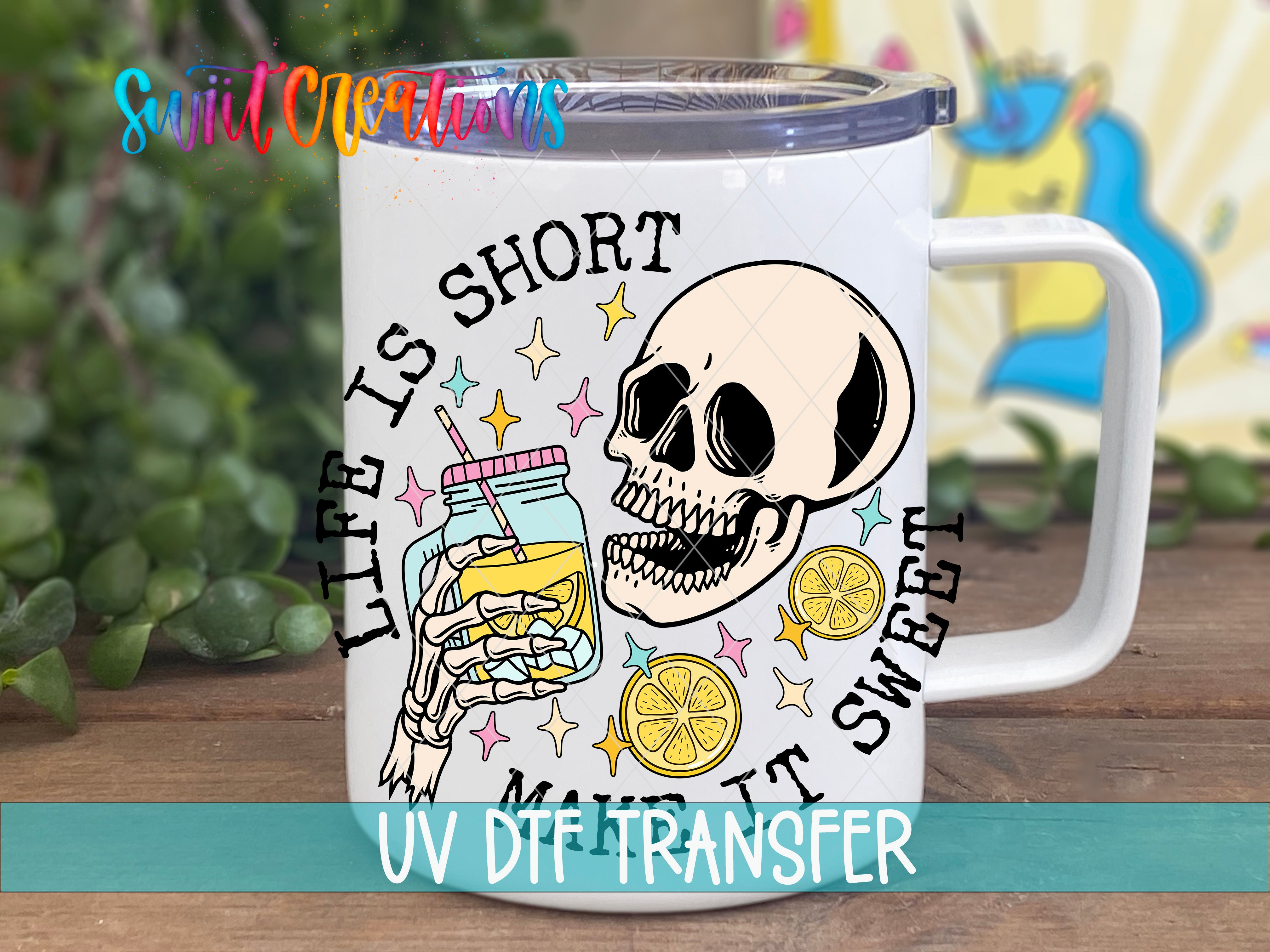 A mug with a skull and a jar of lemonade, along with the text "Life is short, it's sweet" and "UV DFT Transfer".