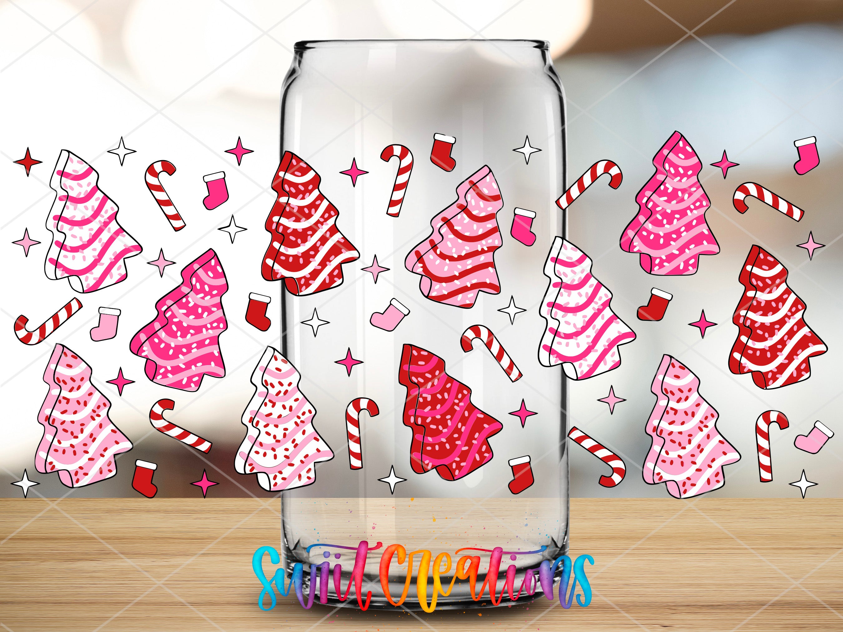 a glass jar with candy canes and christmas trees drawn on it