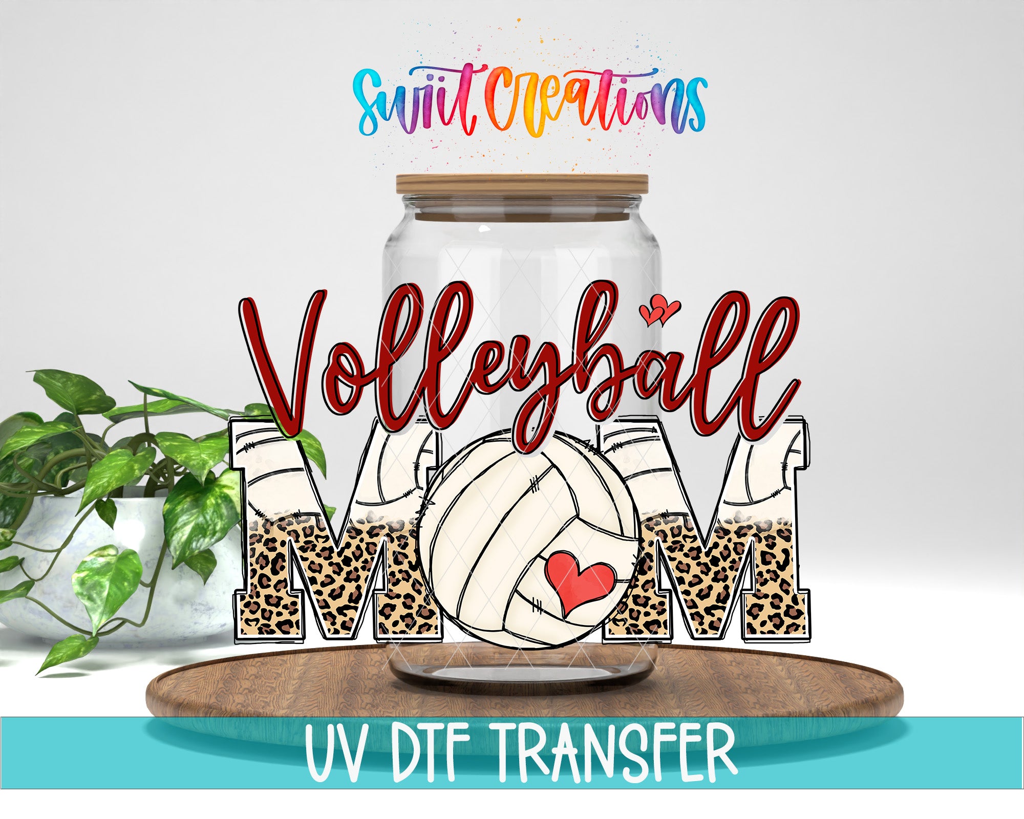 a glass jar with the word "Volleyball Mom" written on it, along with a volleyball and a heart symbol. The jar is placed on a wooden surface, and there is a plant in the background.